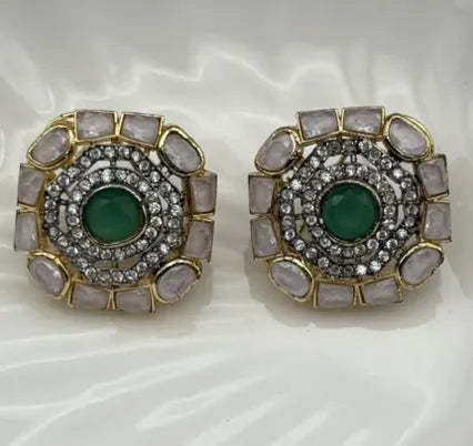 Pair of gold-plated and American diamonds earrings with green gemstones and gold accents on a white background