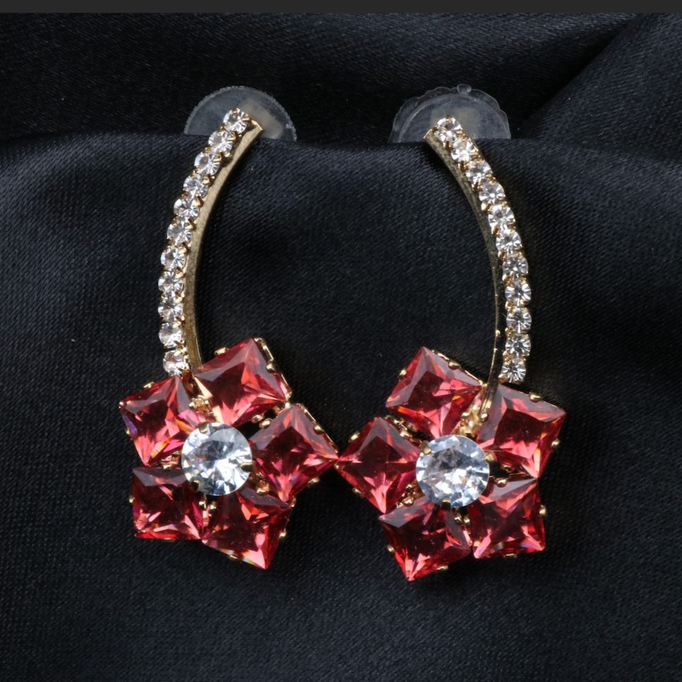 A pair of stainless steel and gold-plated earrings with red and clear American diamonds.