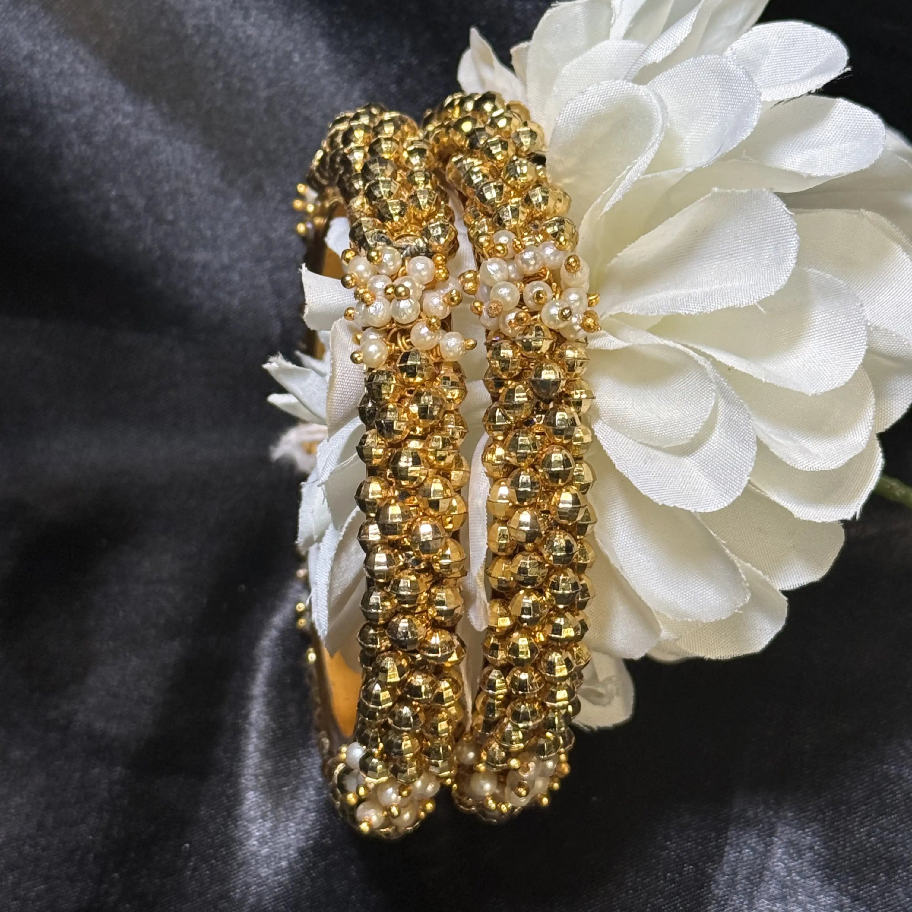 Handcrafted gold beaded bangles with pearl design on black satin
