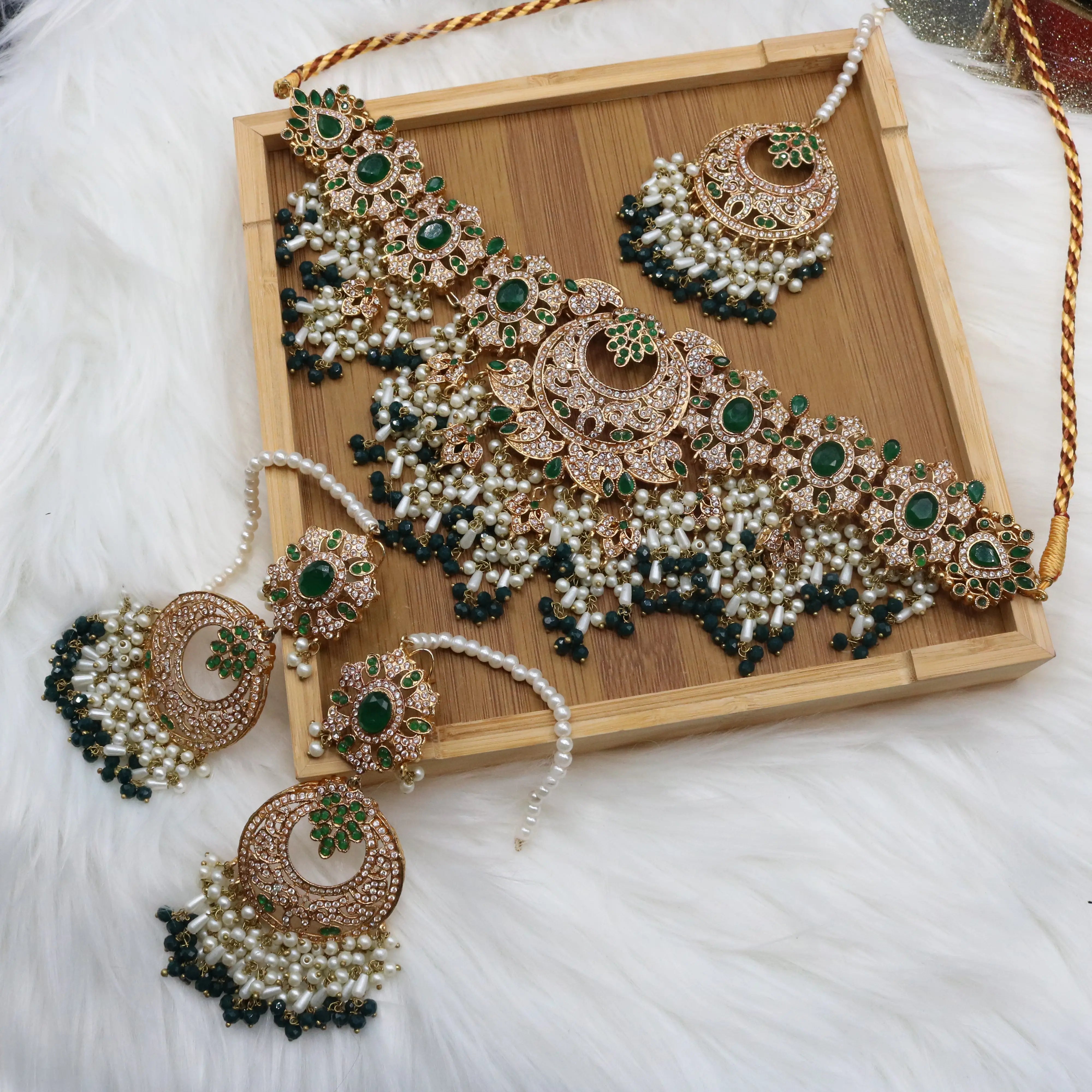 Emerald green bridal choker necklace with earrings and teeka in gold and pearls