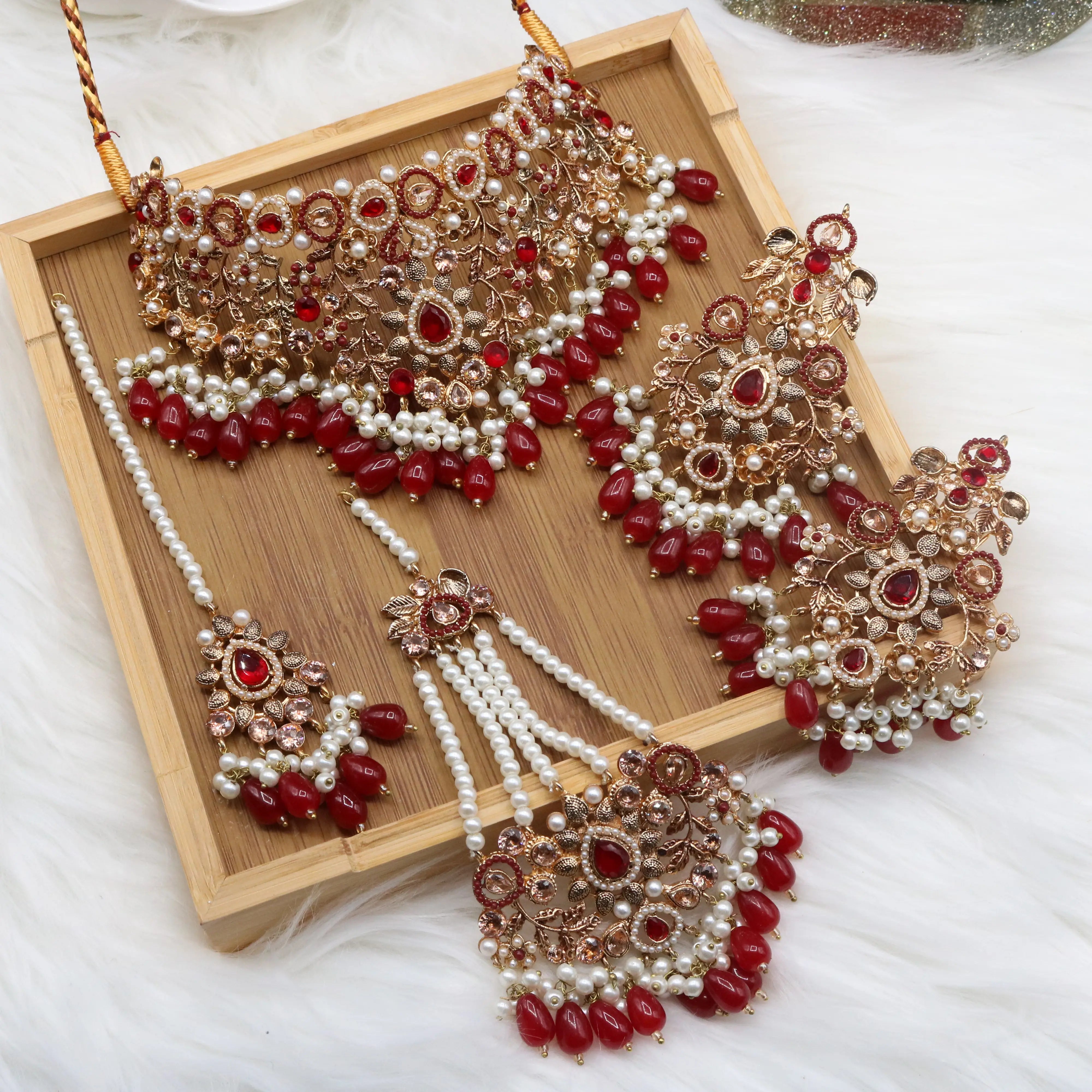 Red bridal choker jewelry set with pearls, earrings, teeka & jhoomer