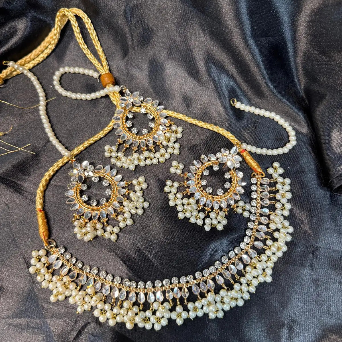 JV143 gold-tone kundan-style necklace set with pearl drops and matching round earrings on black background