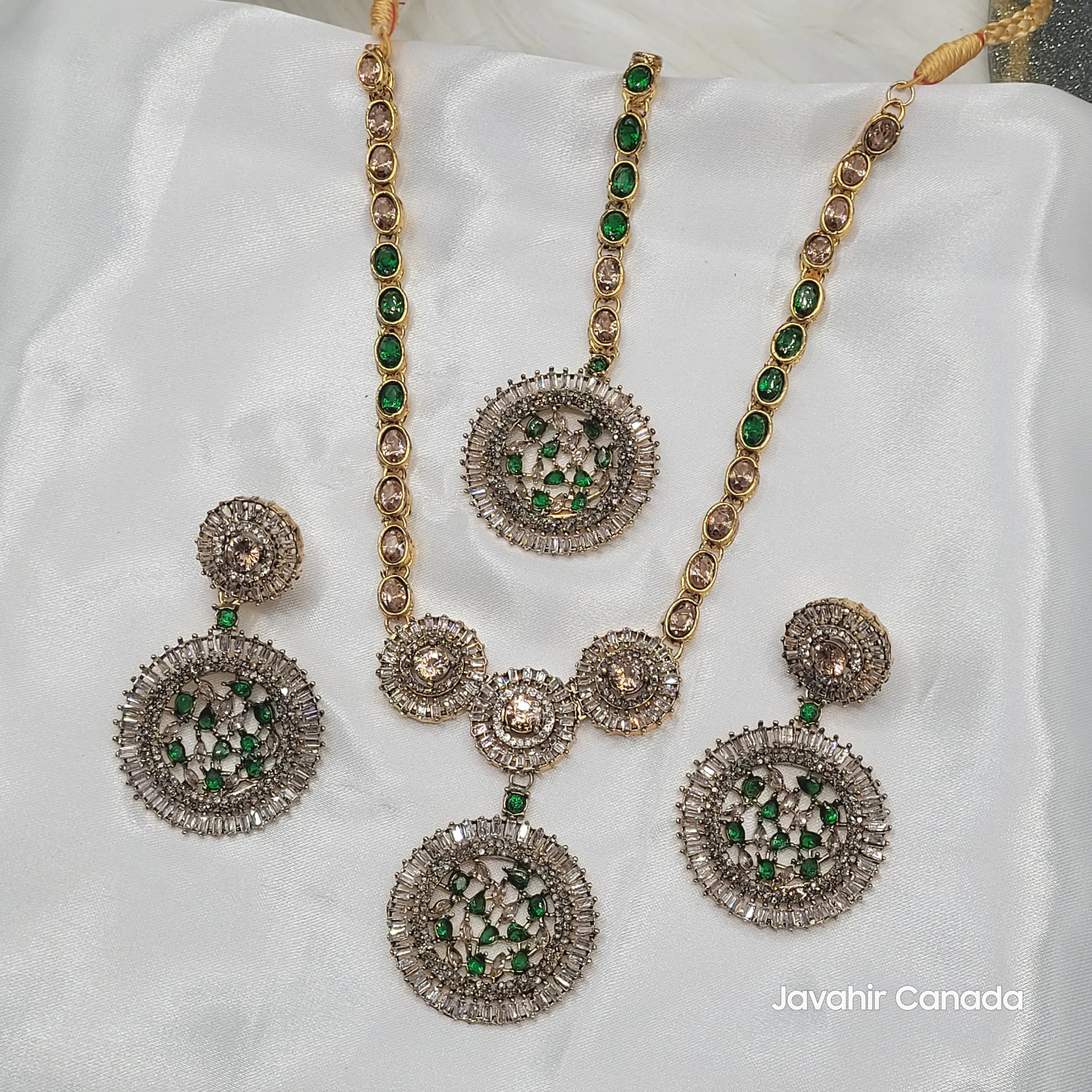 Top view of JV16 green necklace highlighting champagne CZ links and gemstone halo
