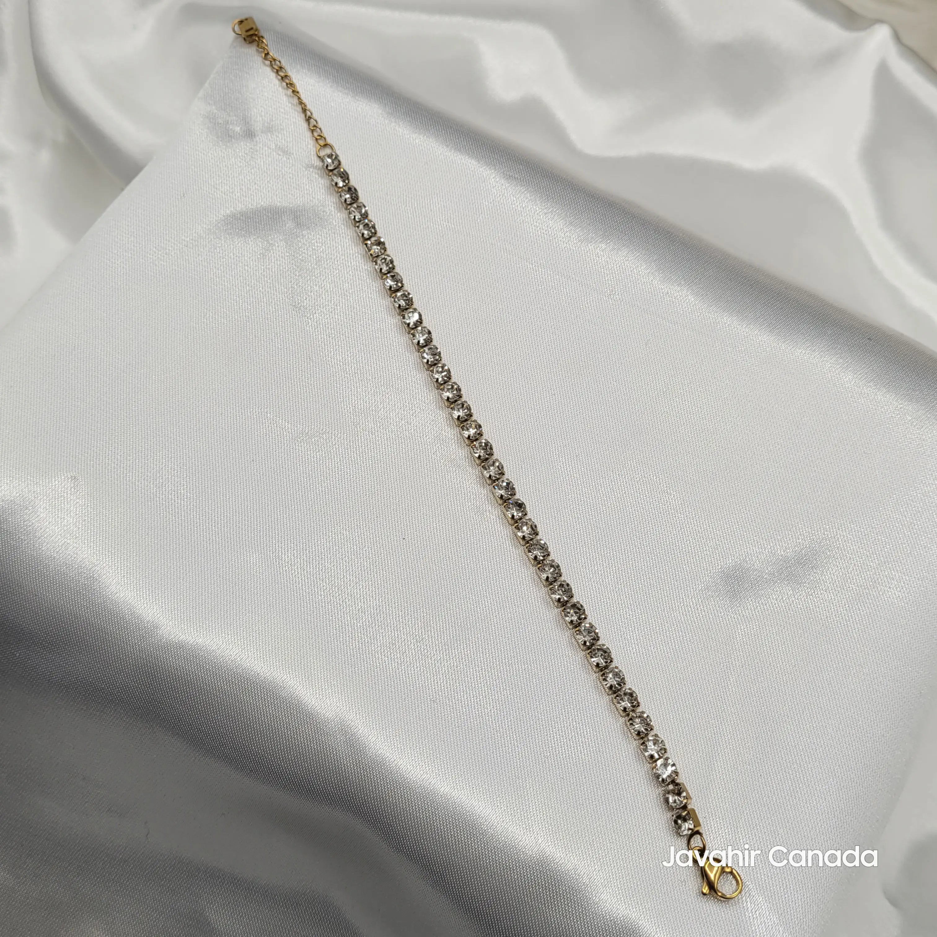 JV4018 gold-plated tennis bracelet with single row of sparkling CZ stones on display