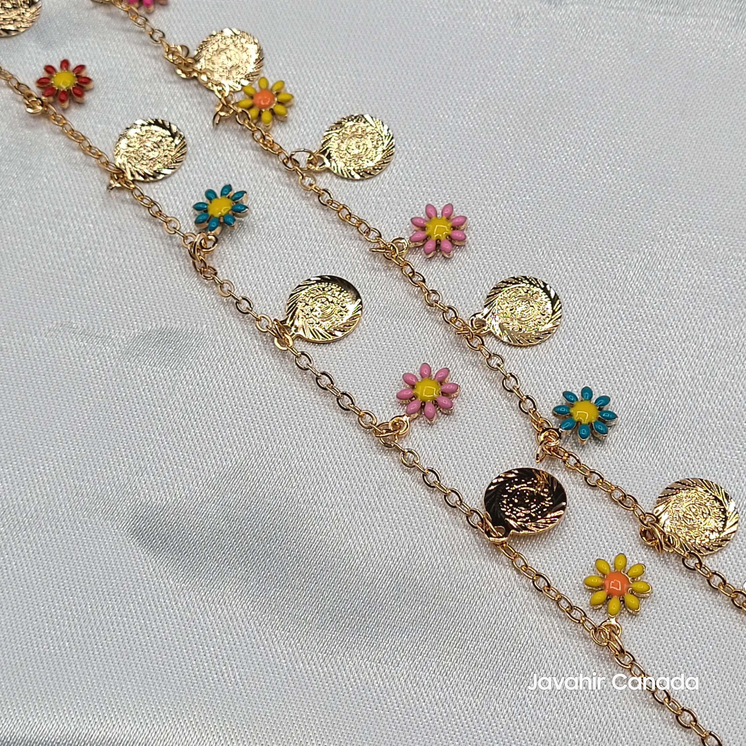 Gold anklet pair featuring bright pink, blue, and yellow flowers