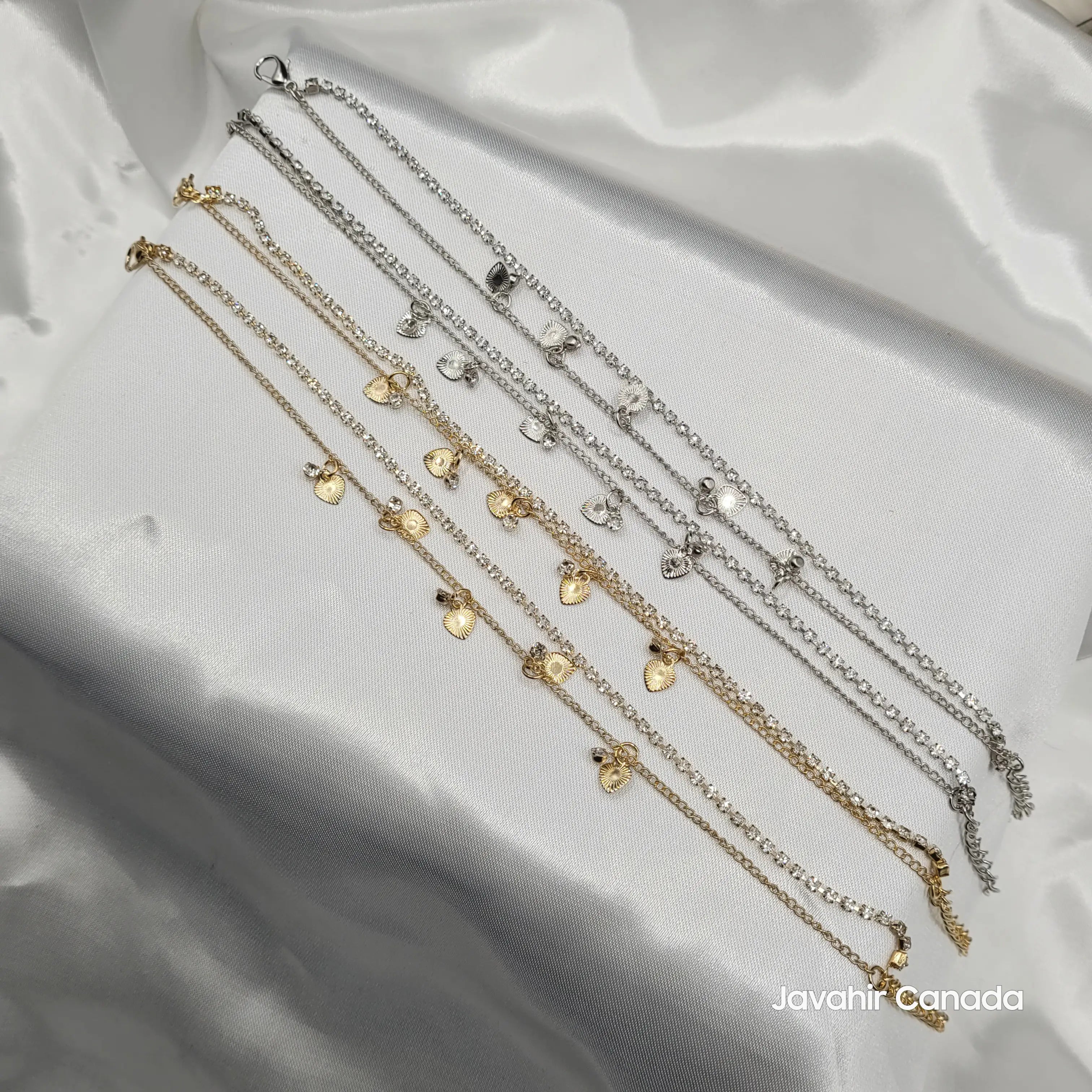JV5010 anklet pair in gold and silver with heart charms and clear crystal accents on satin fabric