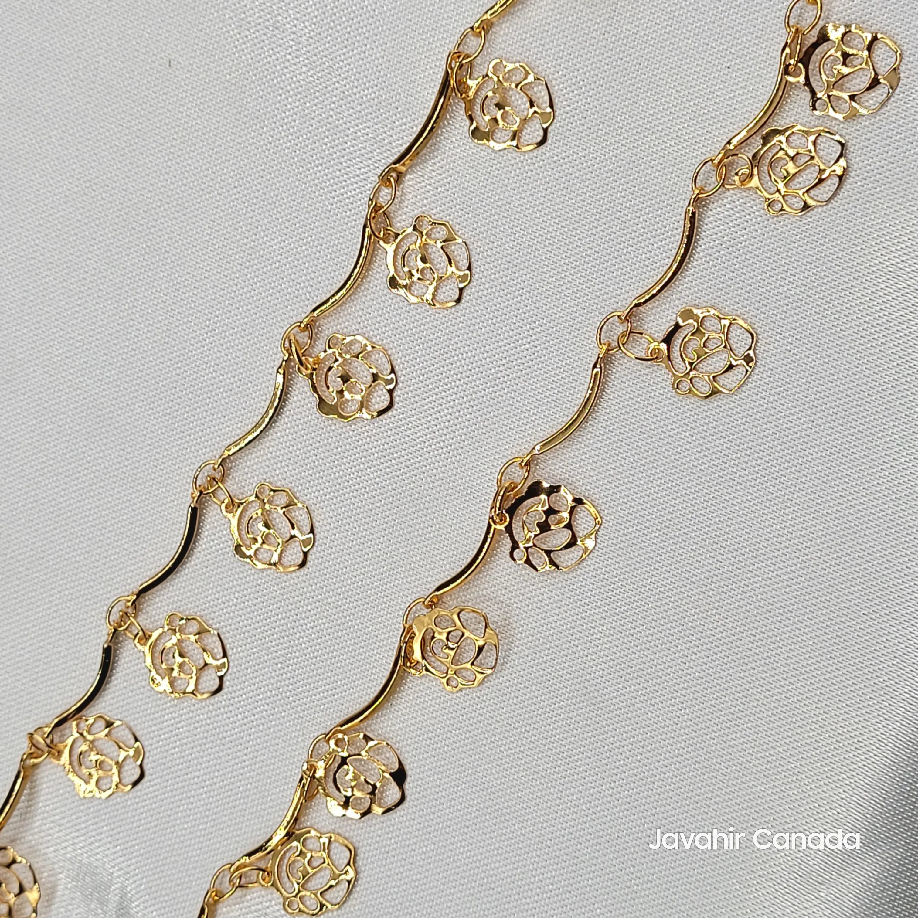 Close-up of JV5014 anklet showing delicate floral gold disc charms and wavy gold chain design