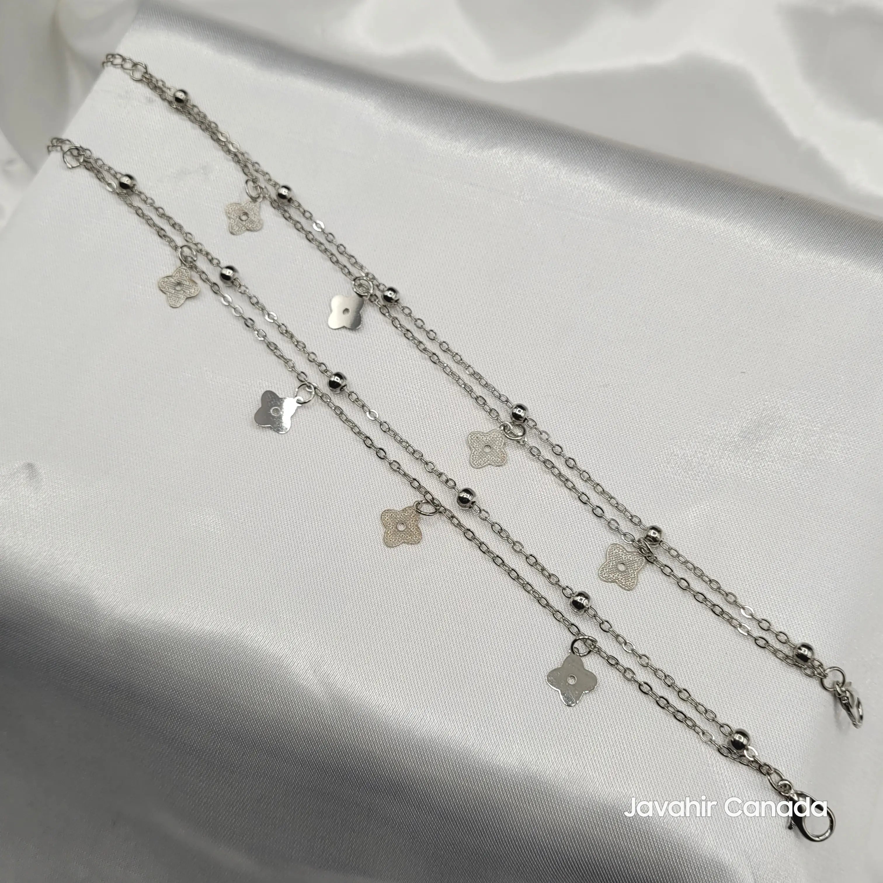 JV5017 silver floral charm anklet pair displayed on white satin background