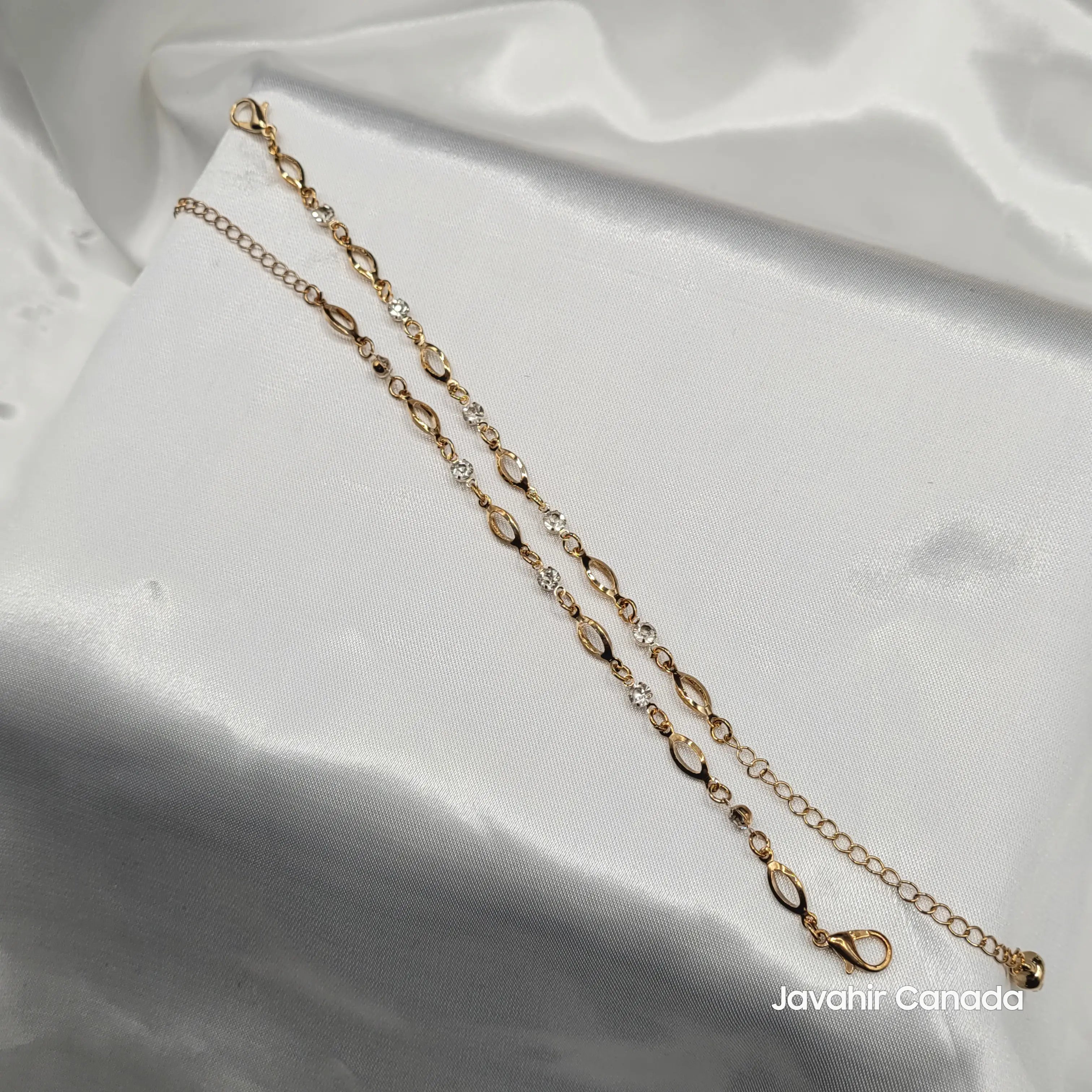 JV5020 gold anklet with alternating oval links and American diamonds displayed on white satin