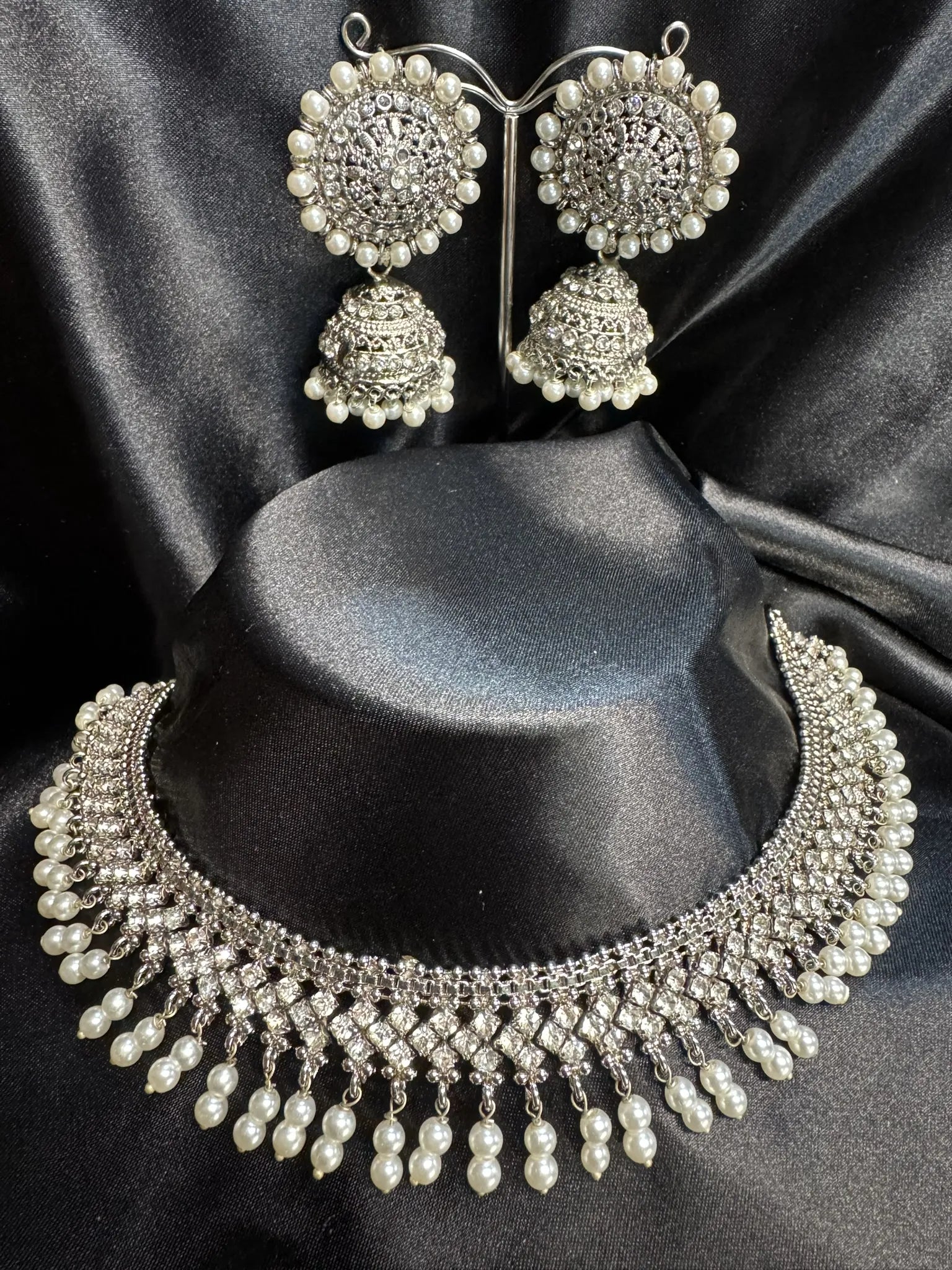 JV59 silver choker necklace with pearl drops and round CZ jhumka earrings on black display
