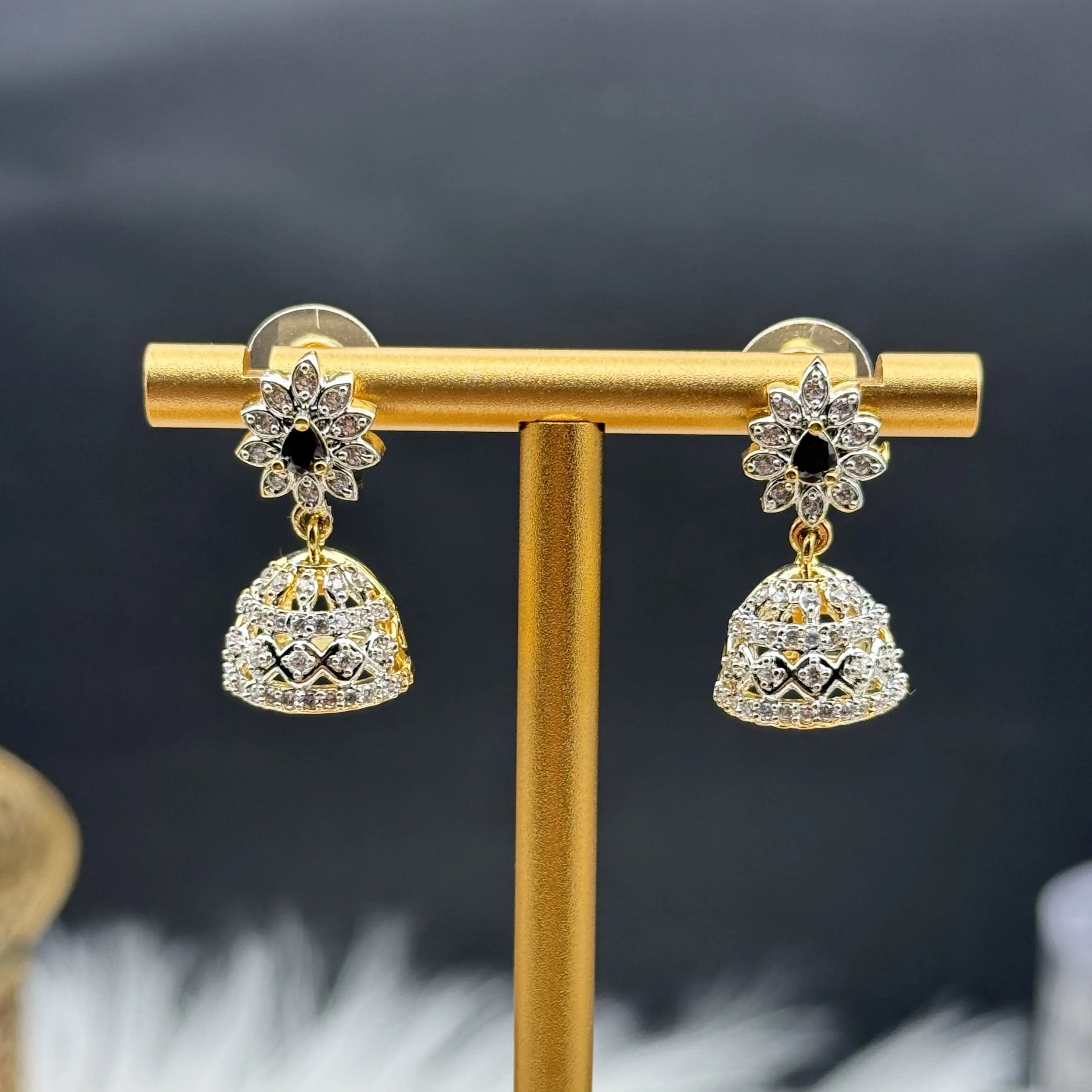 Pair of Pakistani style jhumka earrings with black gemstones and a gold base