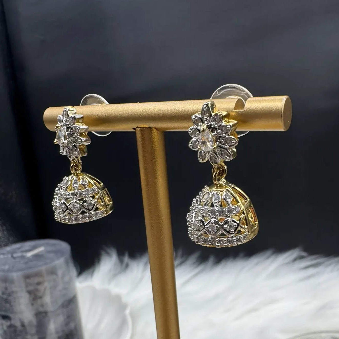 side view of pair of Pakistani style jhumka earrings with clear gemstones