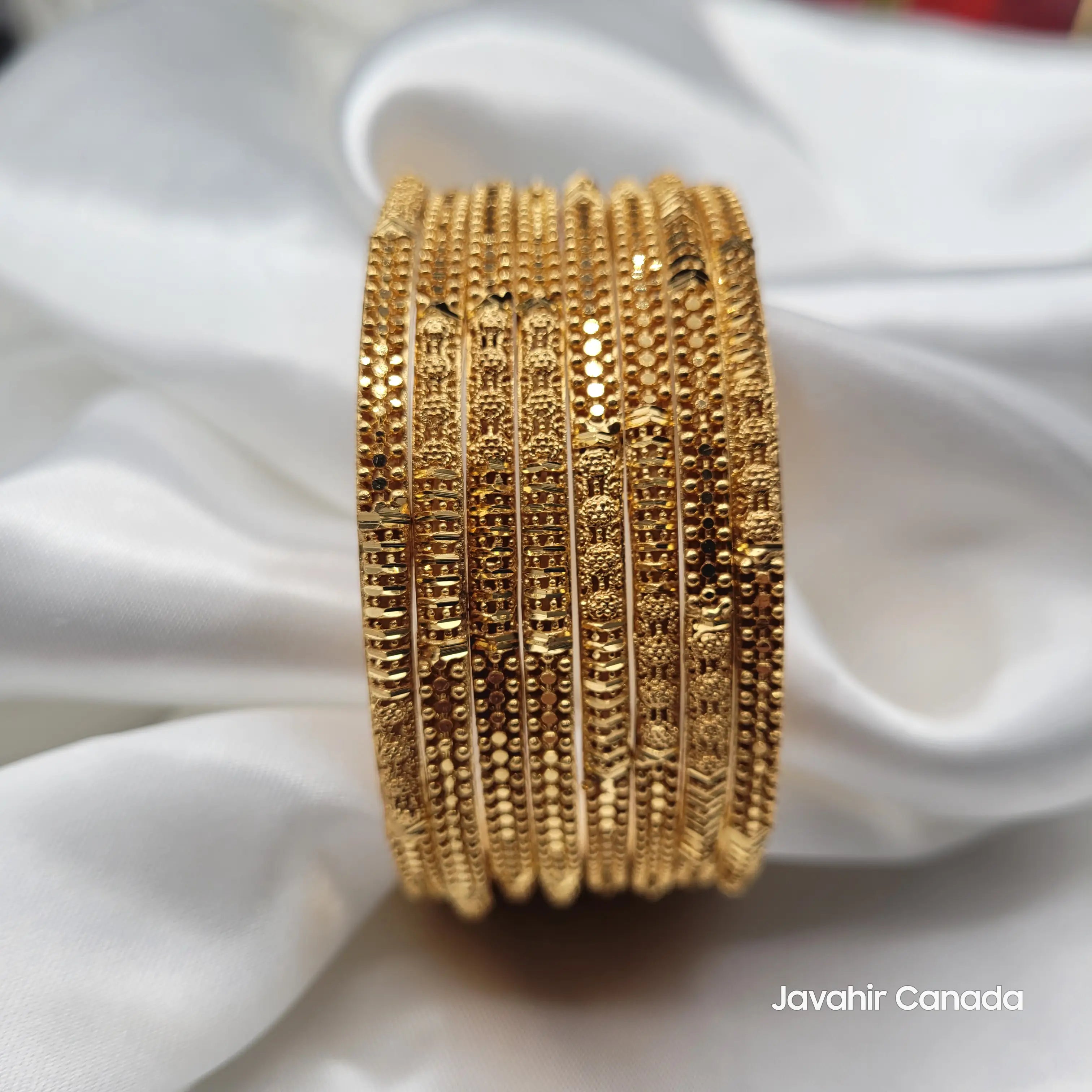 Close-up of 8 intricately designed Pakistani gold bangles