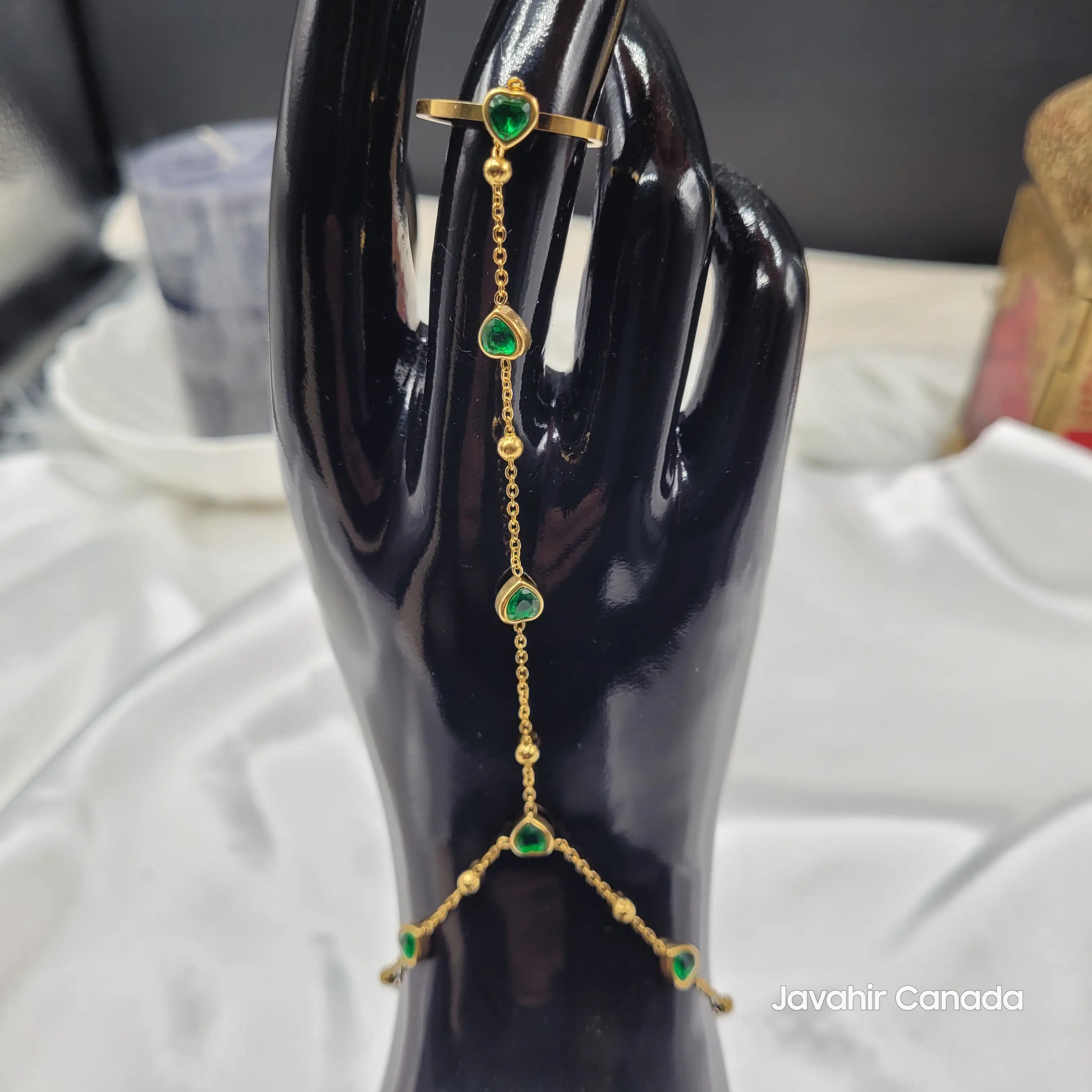 Full front view of JV4023 gold-tone haath phool with emerald green CZ hearts