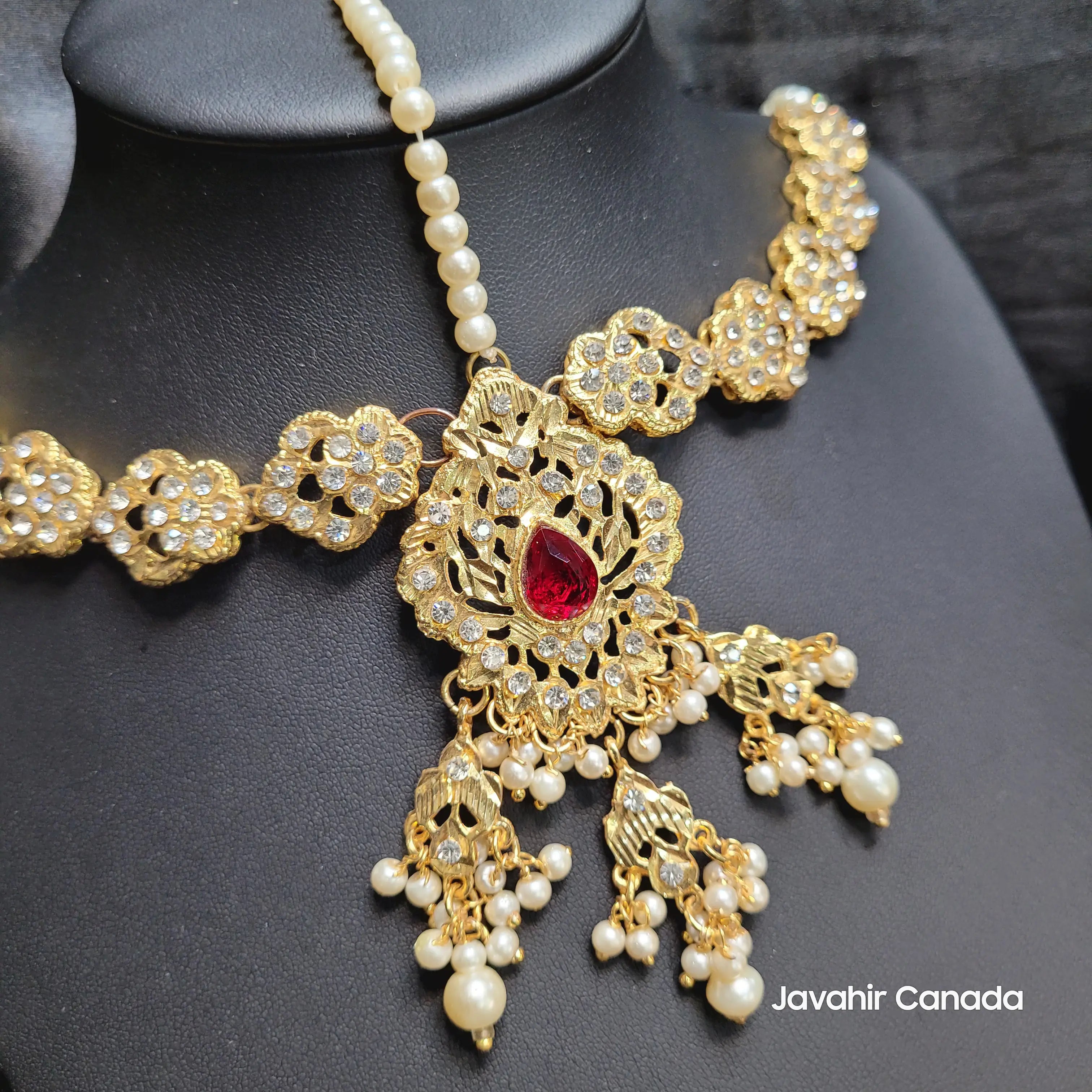 Close-up of JV5120 Maatha Patti with ruby centerpiece and pearl clusters