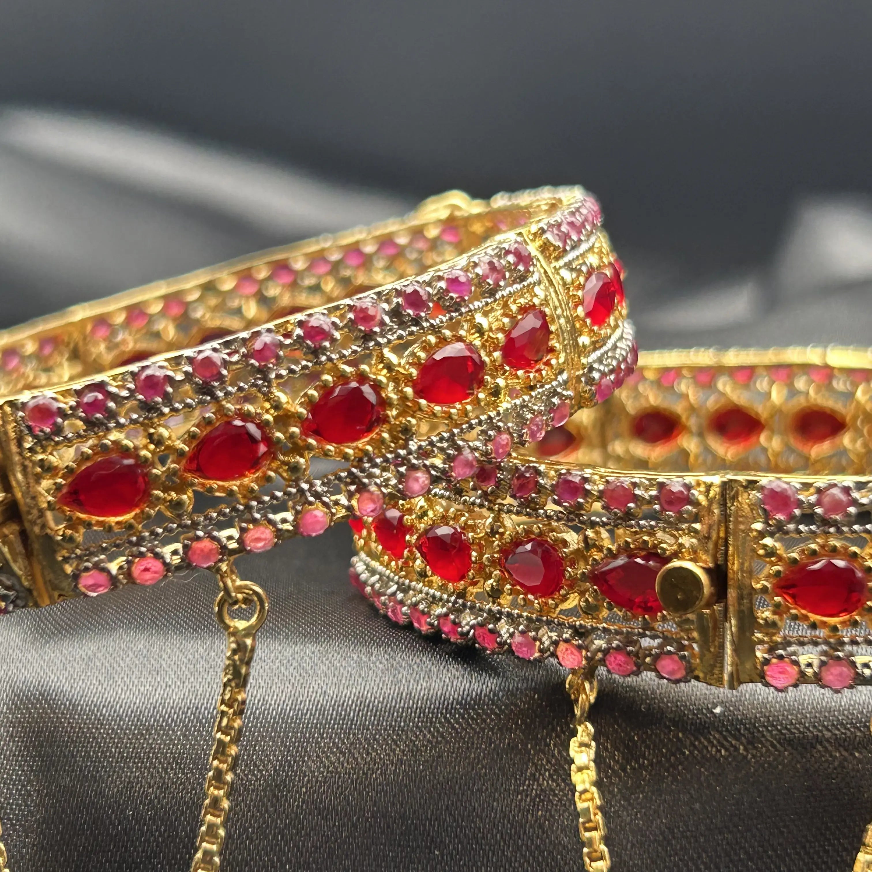 Raindrops gold bangles with red teardrop stones and CZ detailing – front view