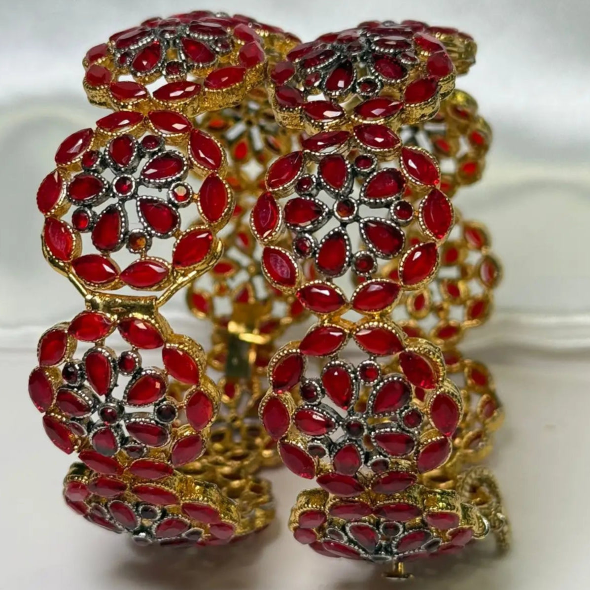 Close-up of Pakistani Celestial red bangles with black detailing