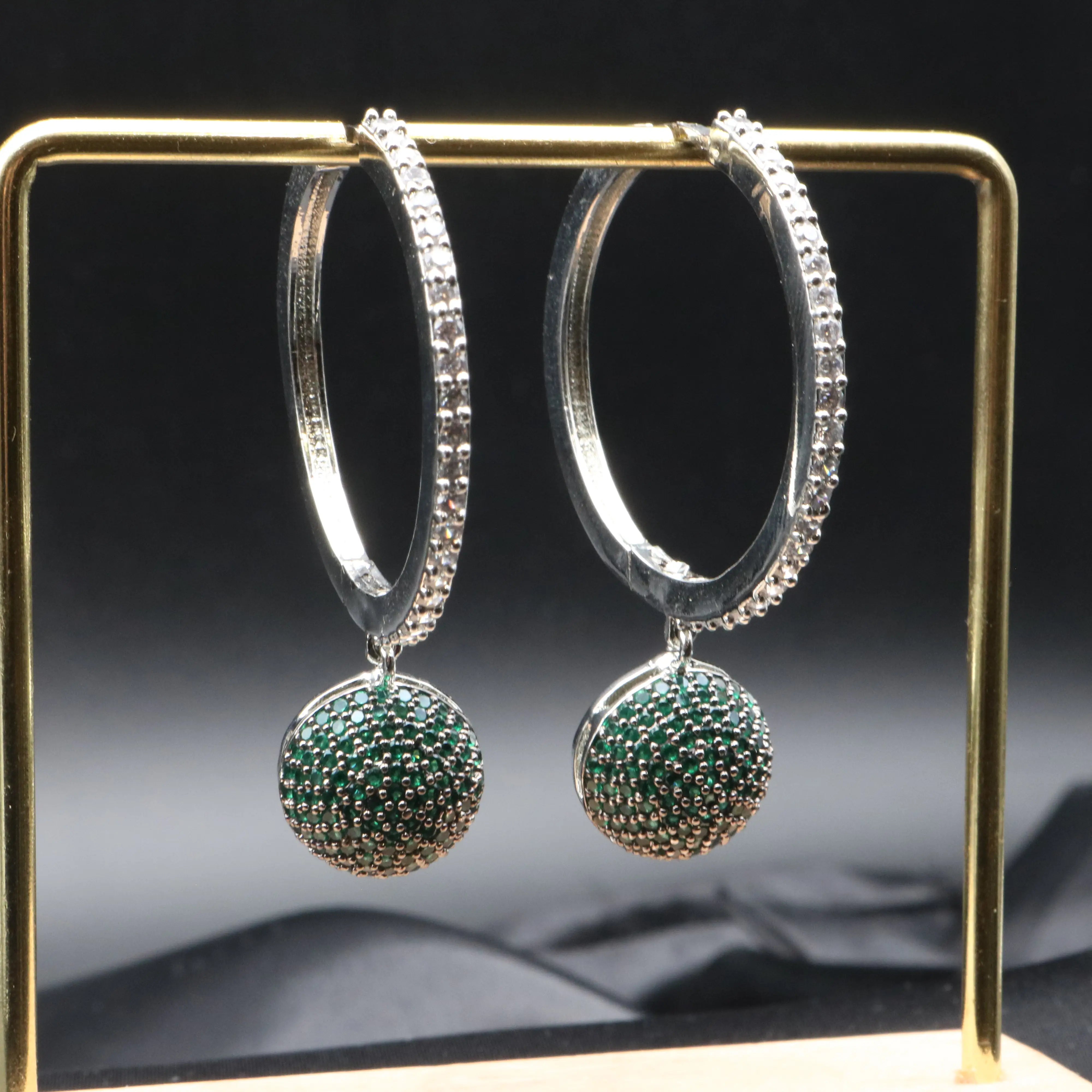 Silver American diamonds hoop earrings with green nano zircons.
