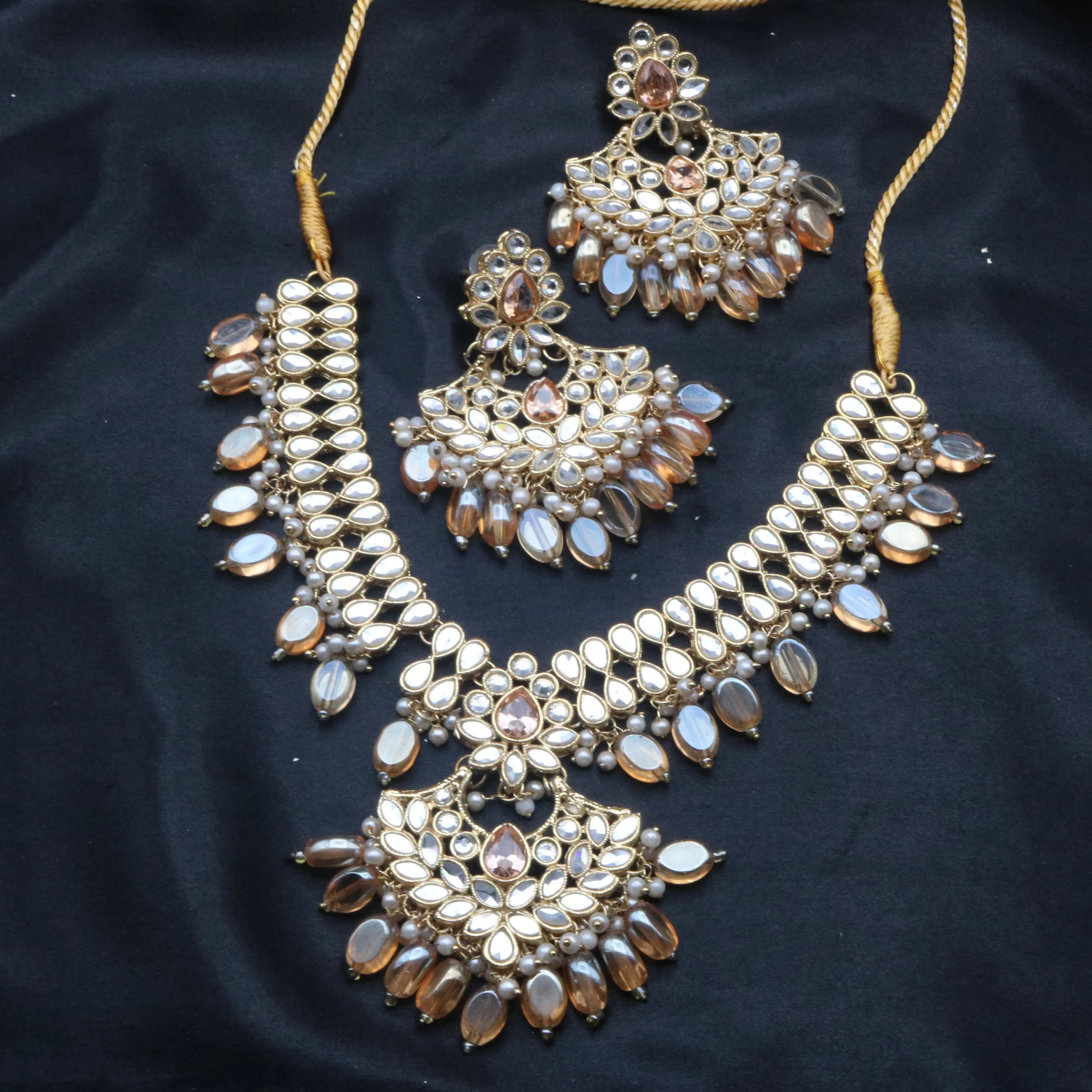 Full Coral necklace set with choker, earrings, and beadwork laid on dark satin background