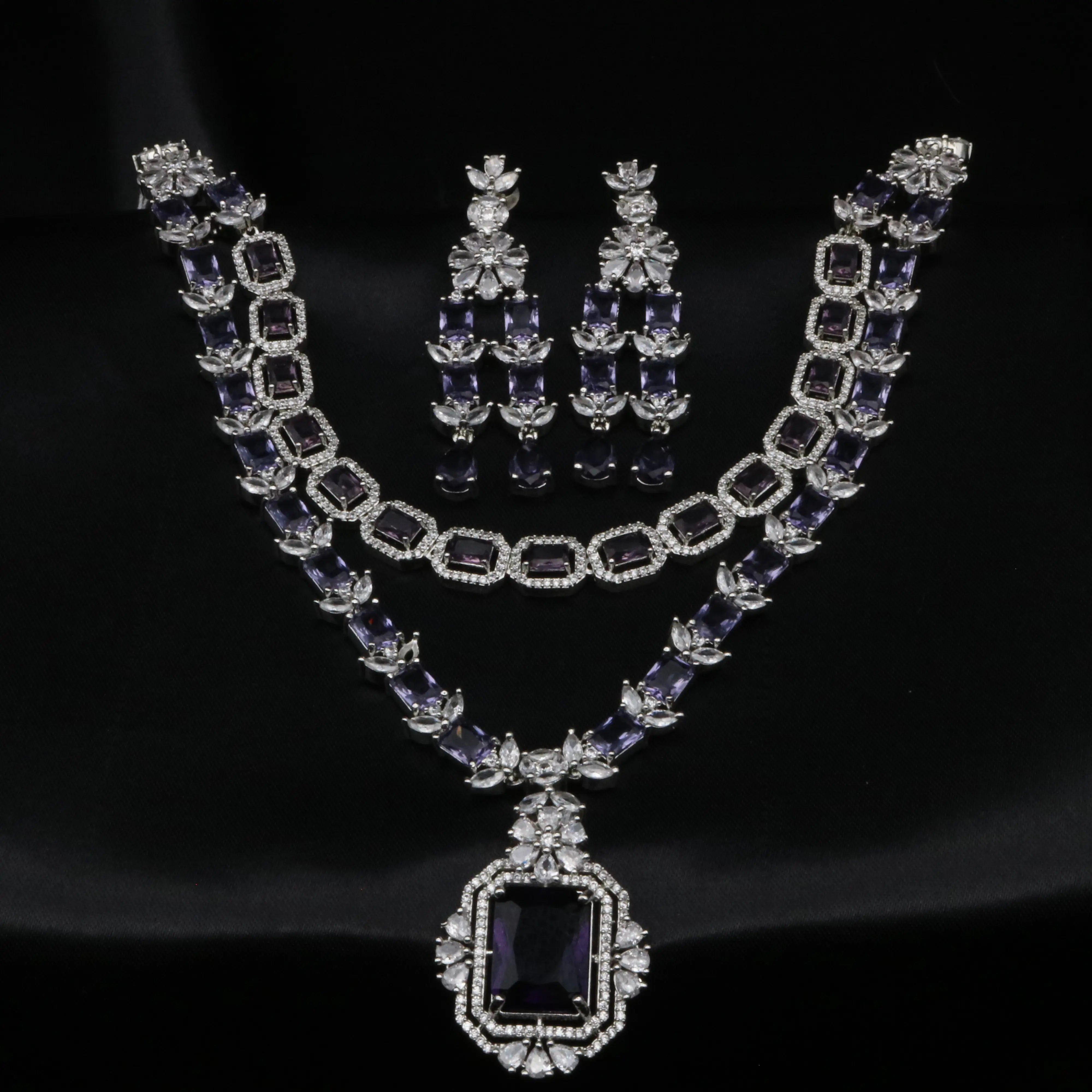 Elegant deep purple CZ necklace set with floral drop earrings displayed on black background