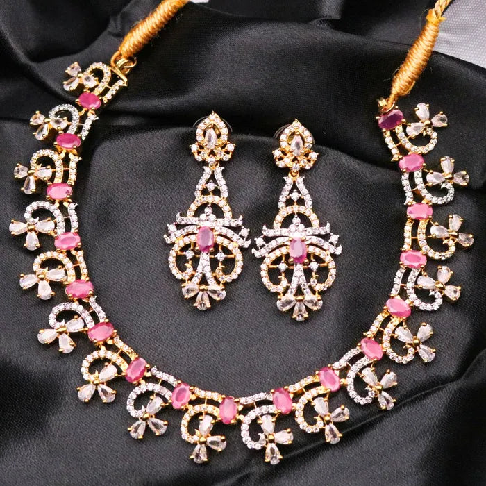 Gold-plated, waterproof and American diamonds based necklace and earrings set with pink stones on a black satin background