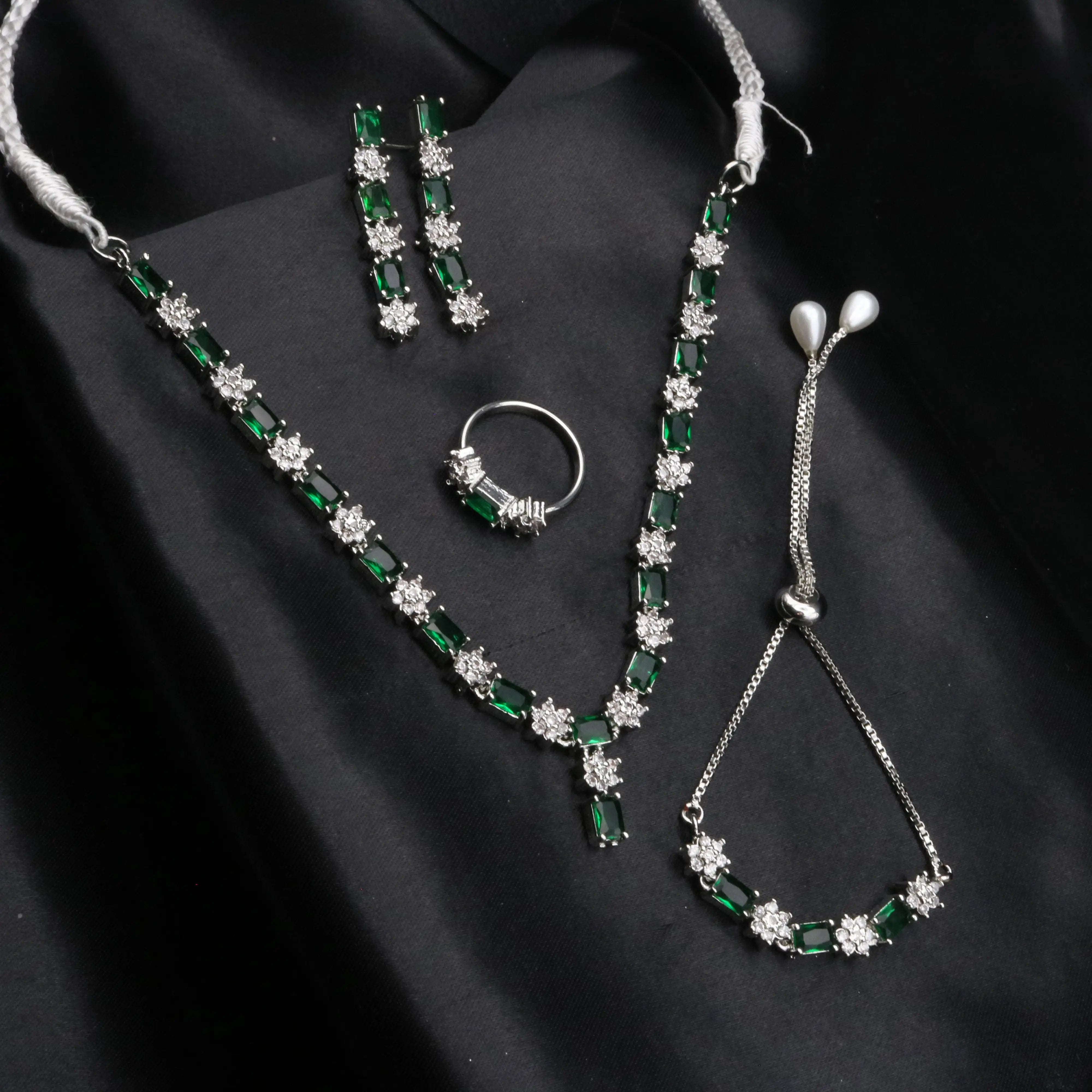 Complete Reverie jewelry set in emerald green – necklace, earrings, ring, bracelet, and teeka