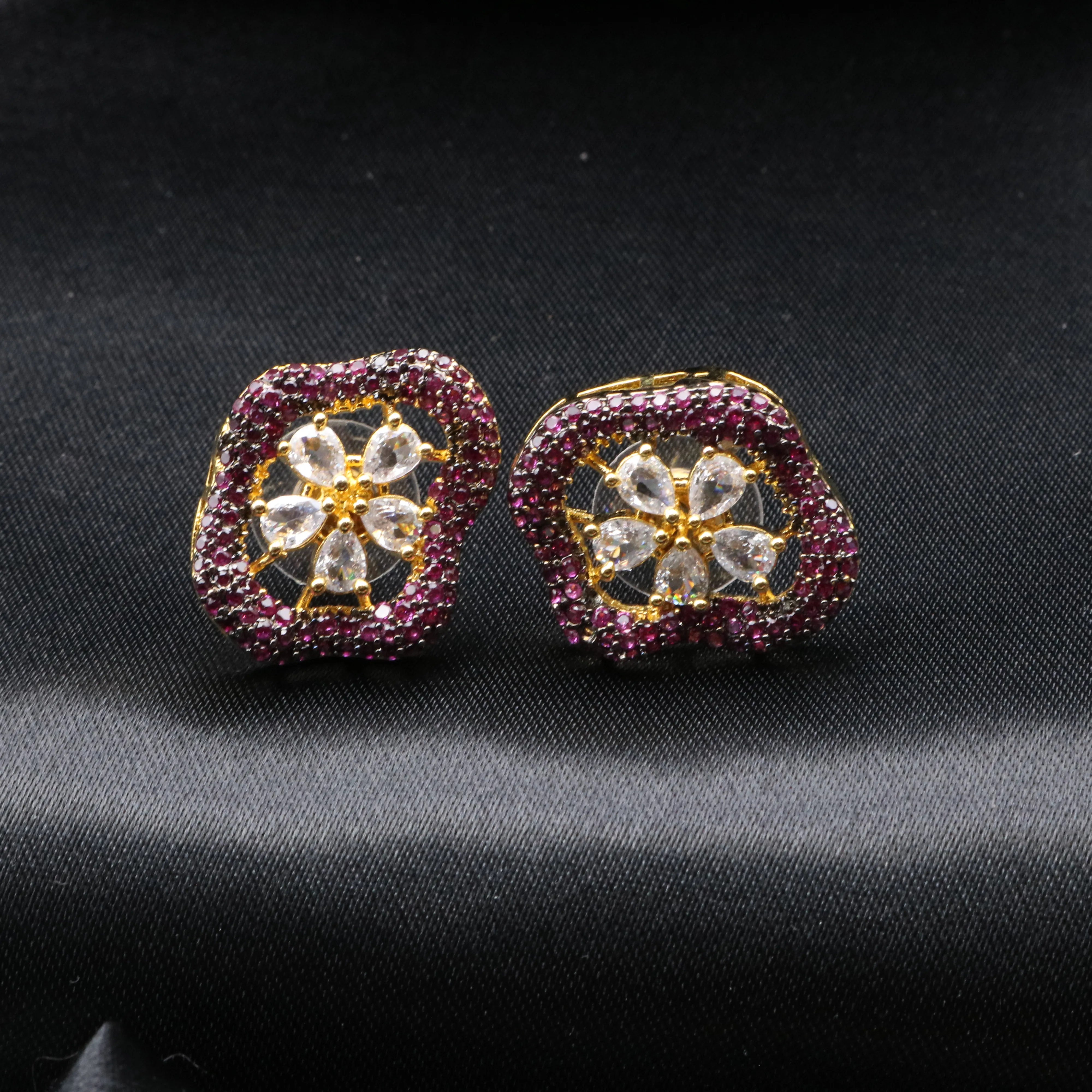 Pair of earrings with gemstones on a black background