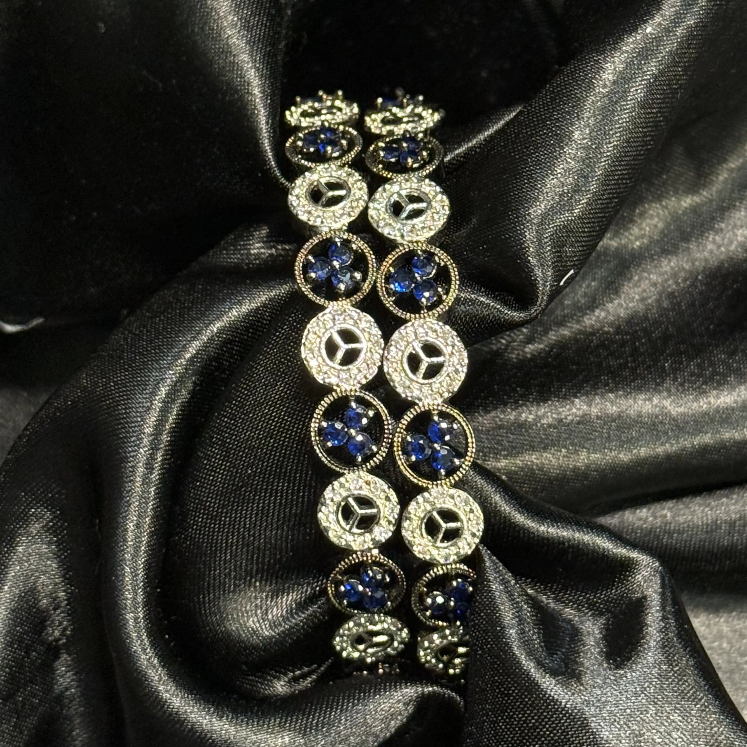 Blue floral and diamond circle bangles on black satin