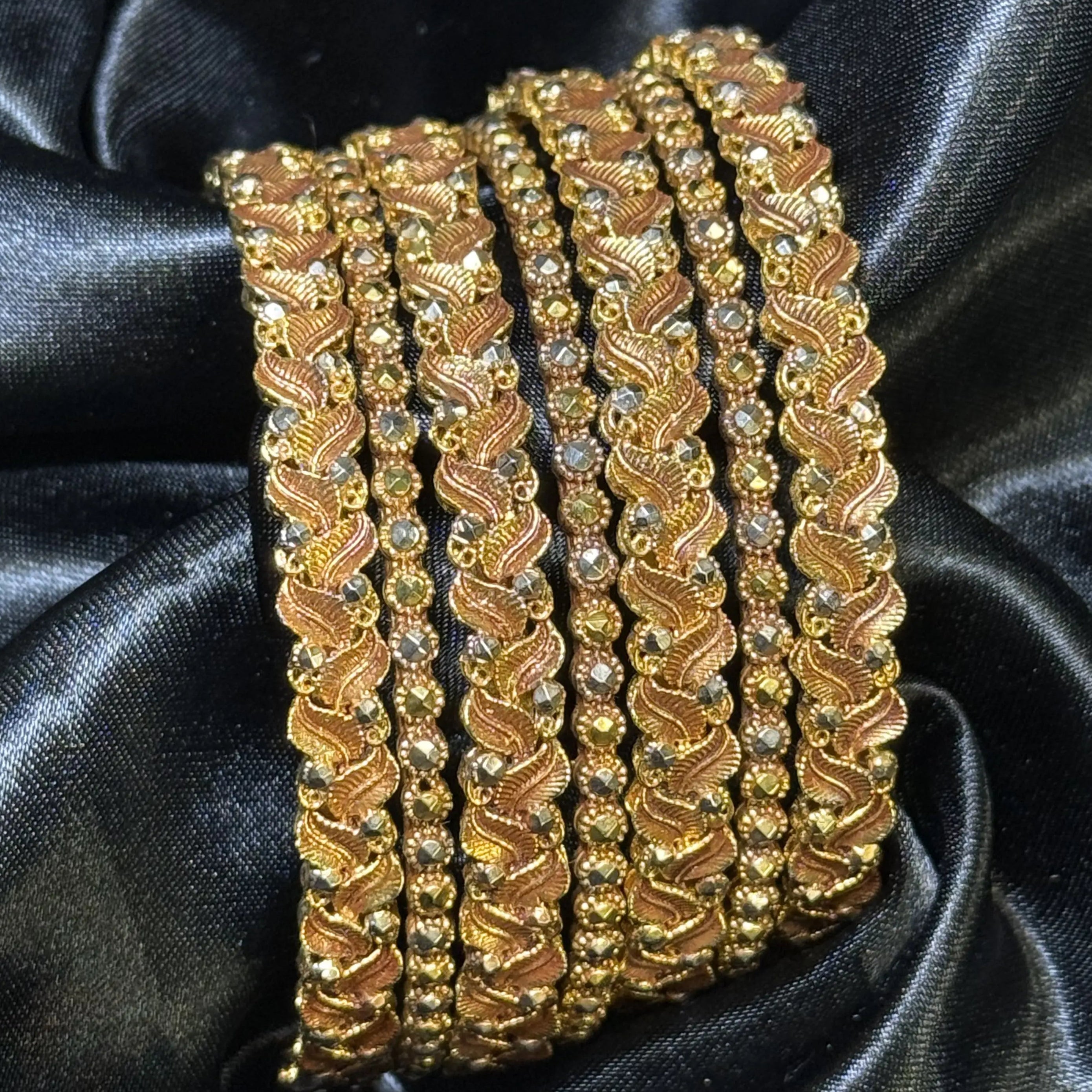 Pakistani gold bangle set – mixed widths with antique finish. Traditional bridal bangles with textured detailing and durable polish