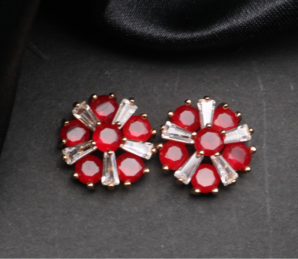Pair of red floral earrings with clear gemstones on a dark background. Waterproof and anti-tarnish
