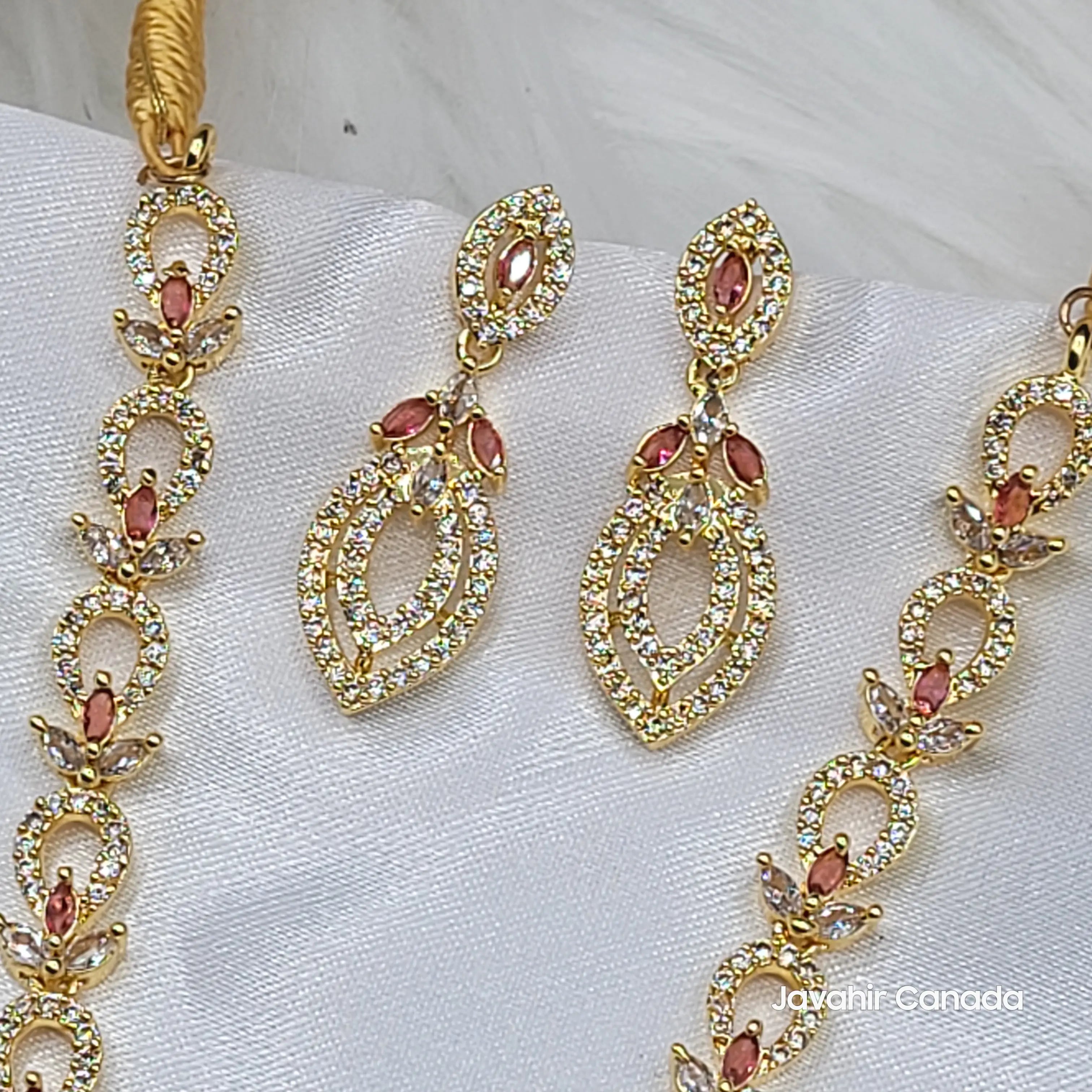 Matching earrings and necklace in rose red variant on white satin.