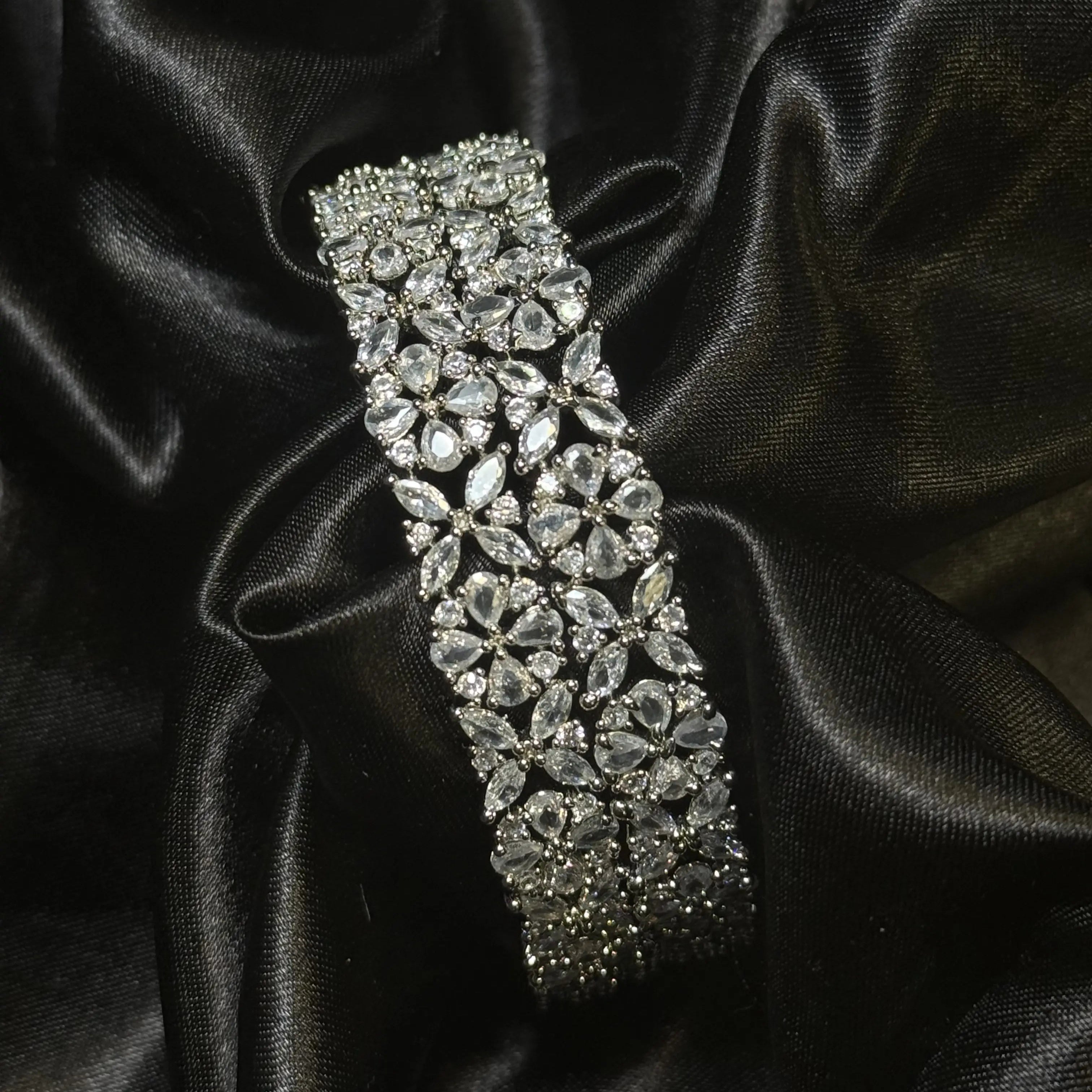 Silver floral bangle with American diamonds on black satin