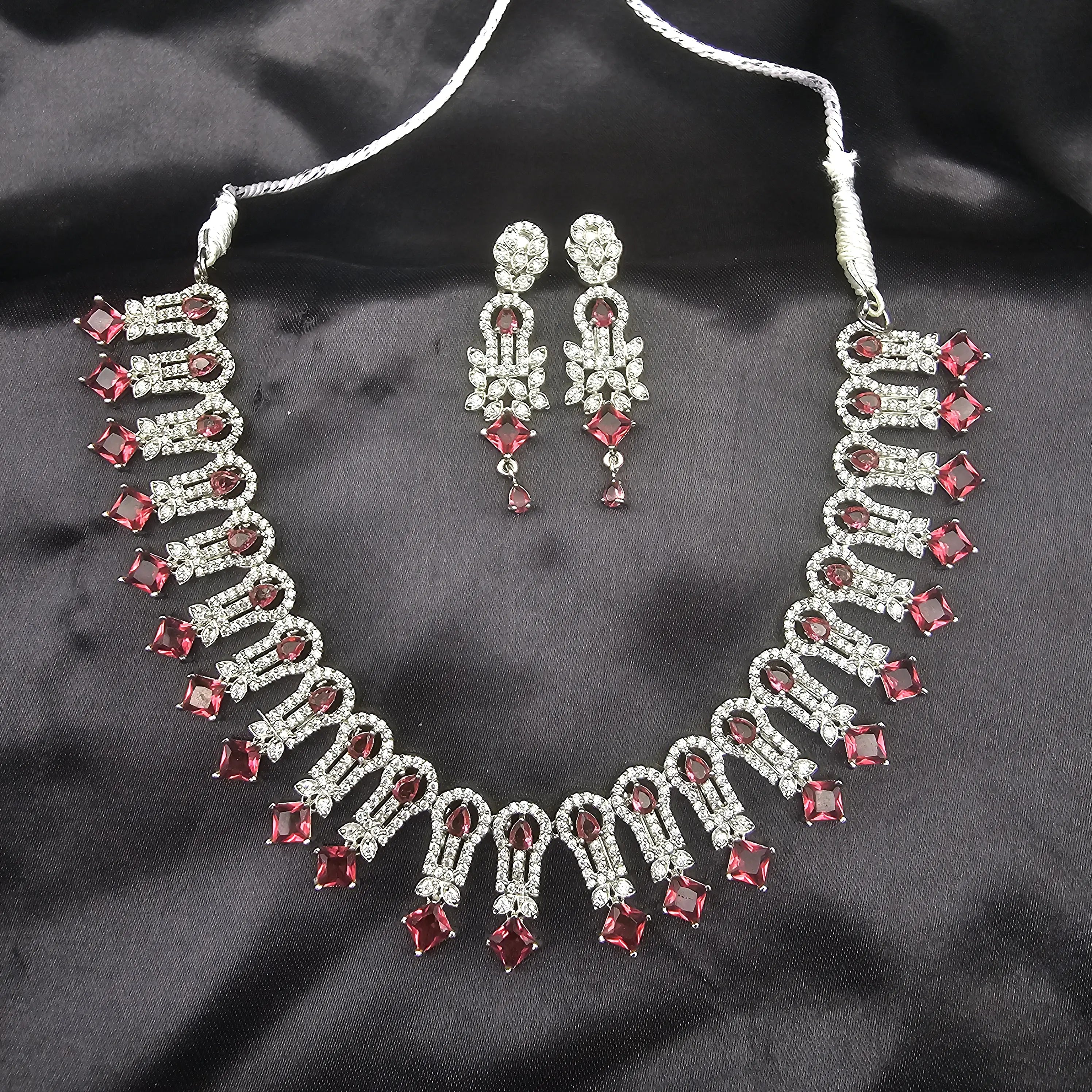 Complete Euphoric jewelry set displayed with choker necklace and drop earrings in silver-tone with ruby red accents.