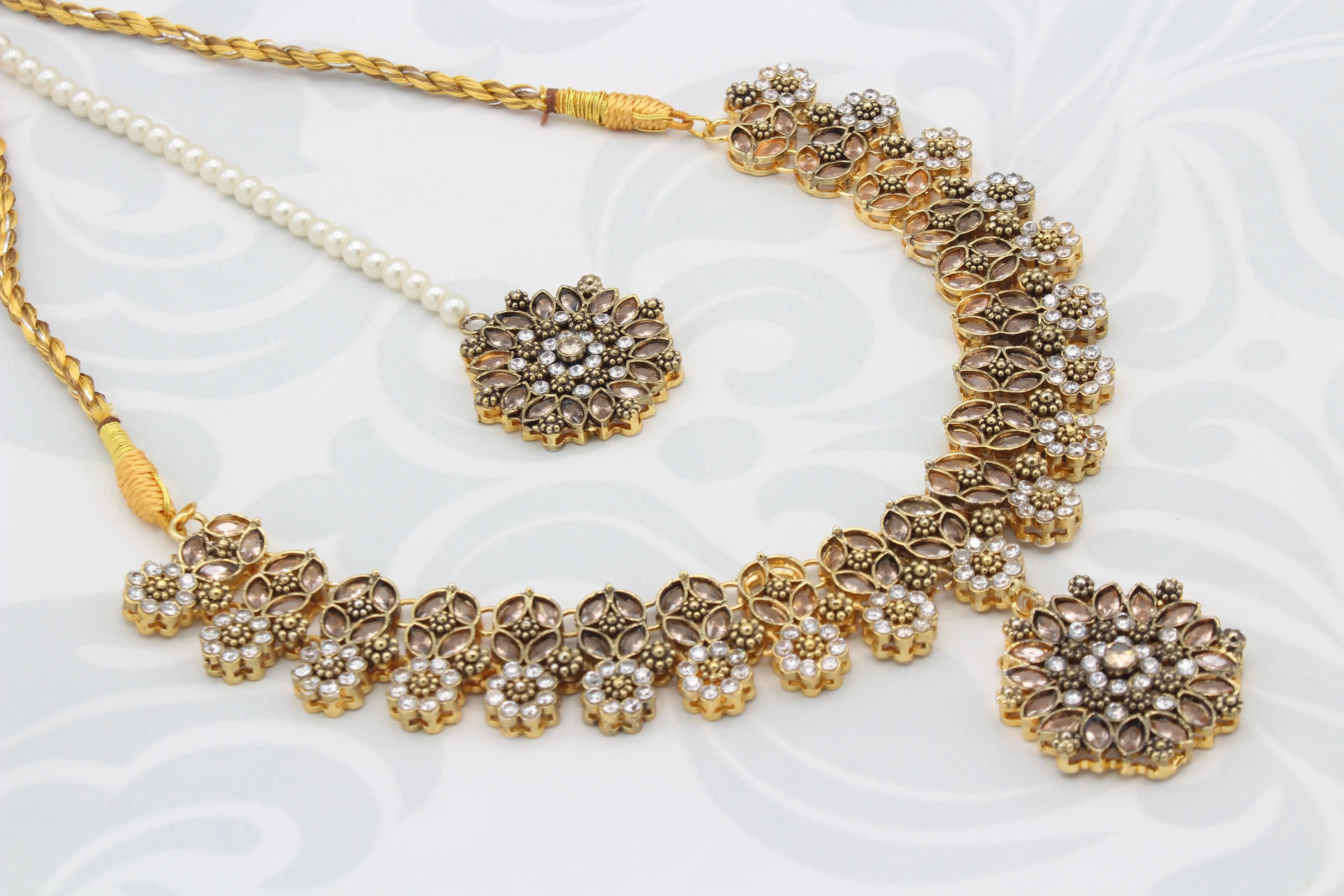 Overhead view of necklace set with pearl-stringed pendant