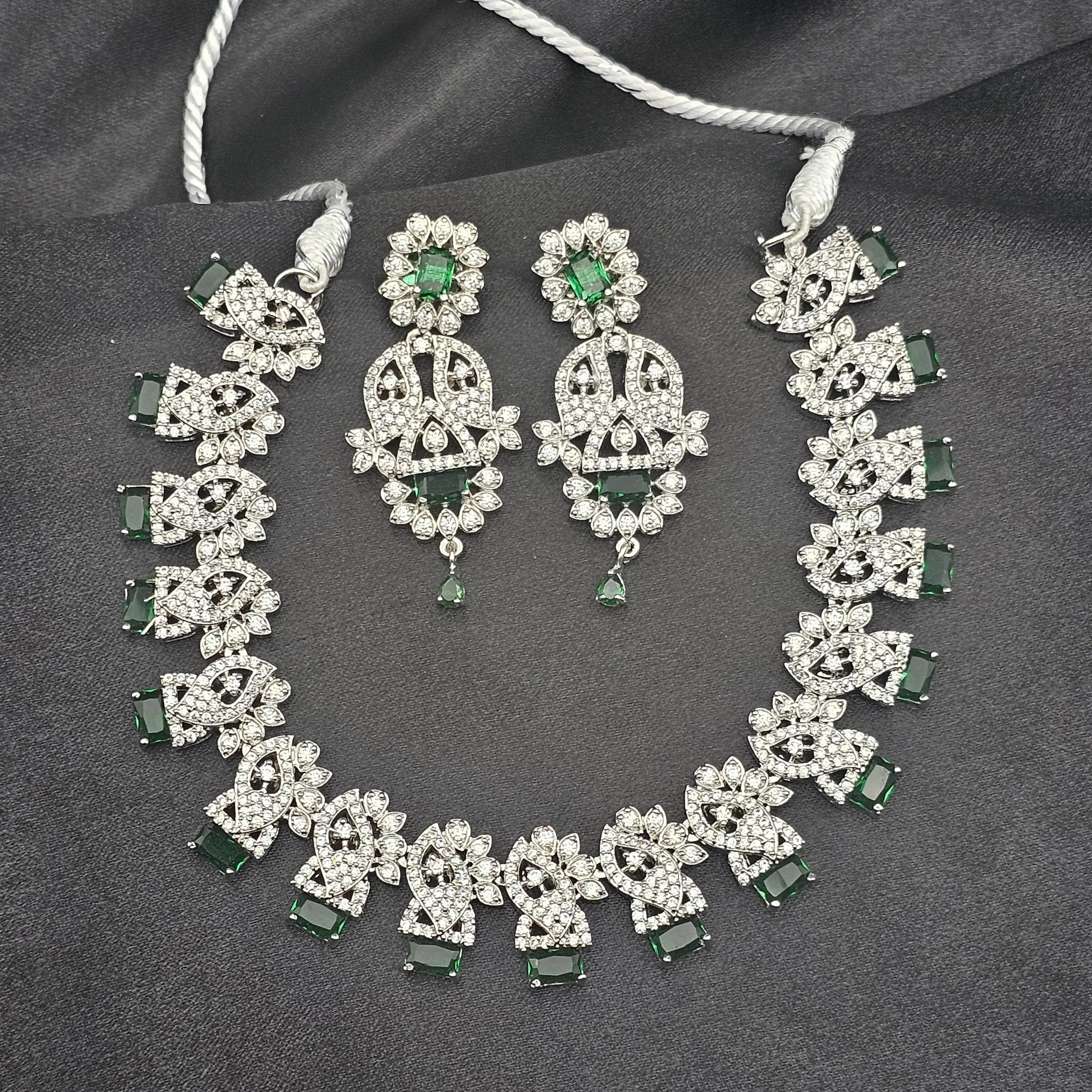 Close-up view of Felicity necklace highlighting green CZ stones and American diamond accents.