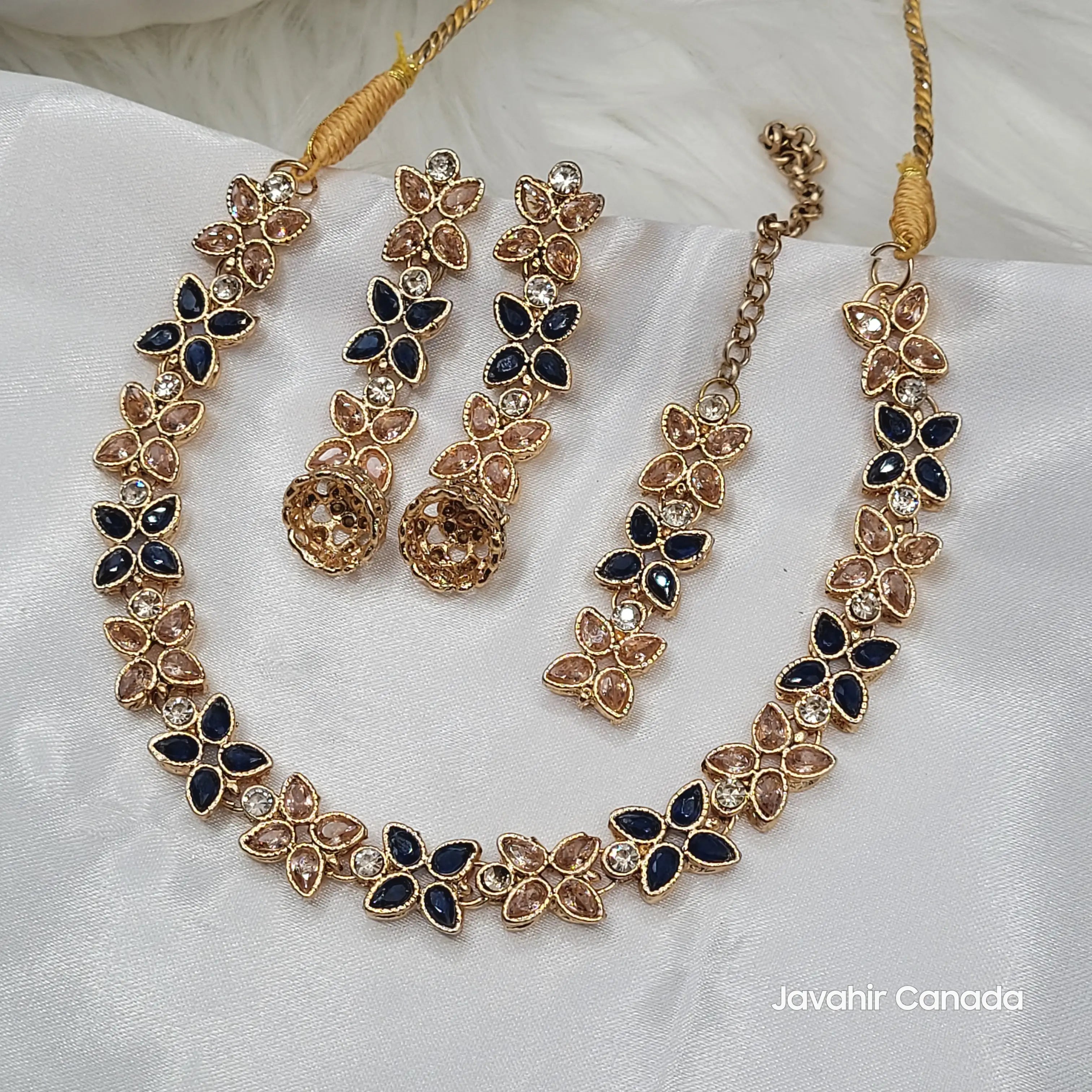 Flora necklace set featuring a mix of navy blue and champagne marquise CZ stones on white background.