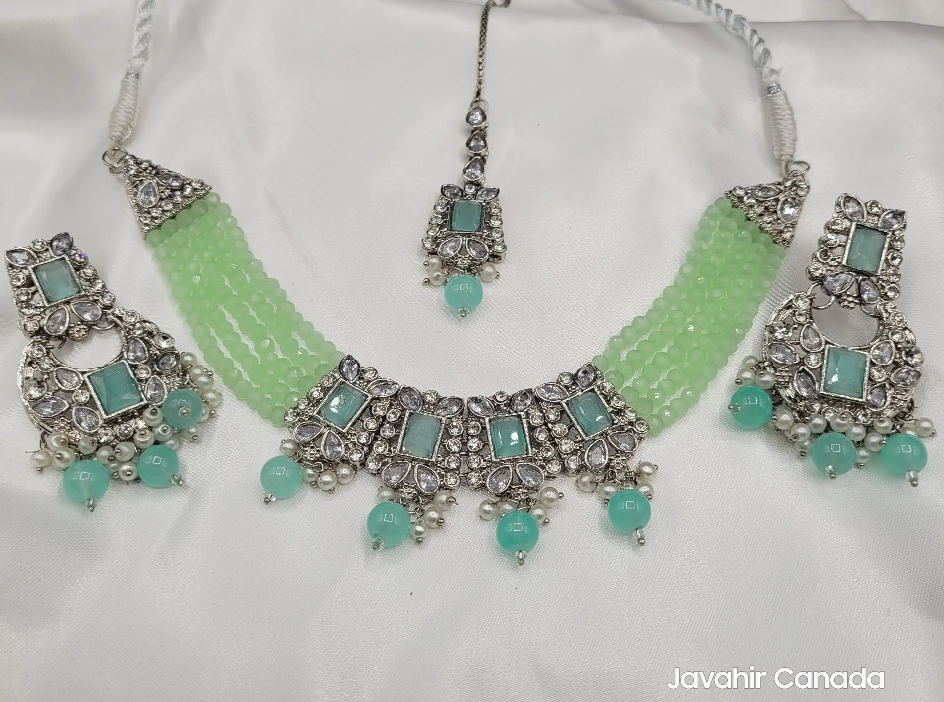 Complete flatlay of Firdous mint green necklace set with earrings and center pendant.