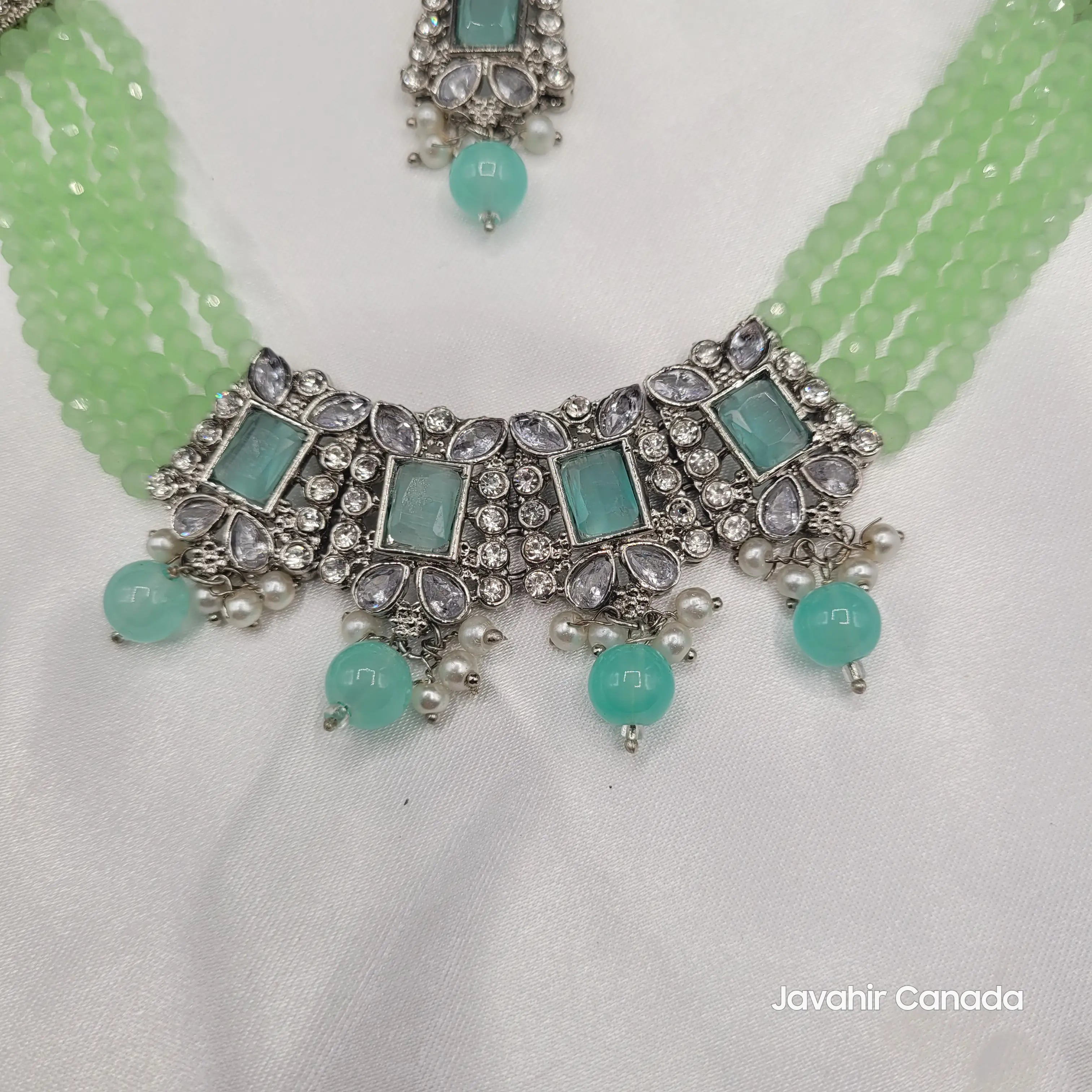 Detail of necklace centerpiece in aqua mint variant with silver finish