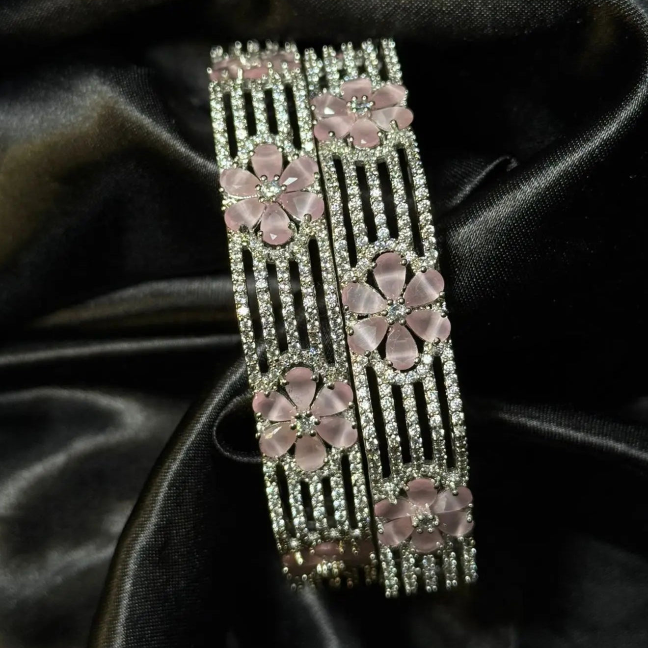 Elegant pink crystal bangles for women on luxurious fabric