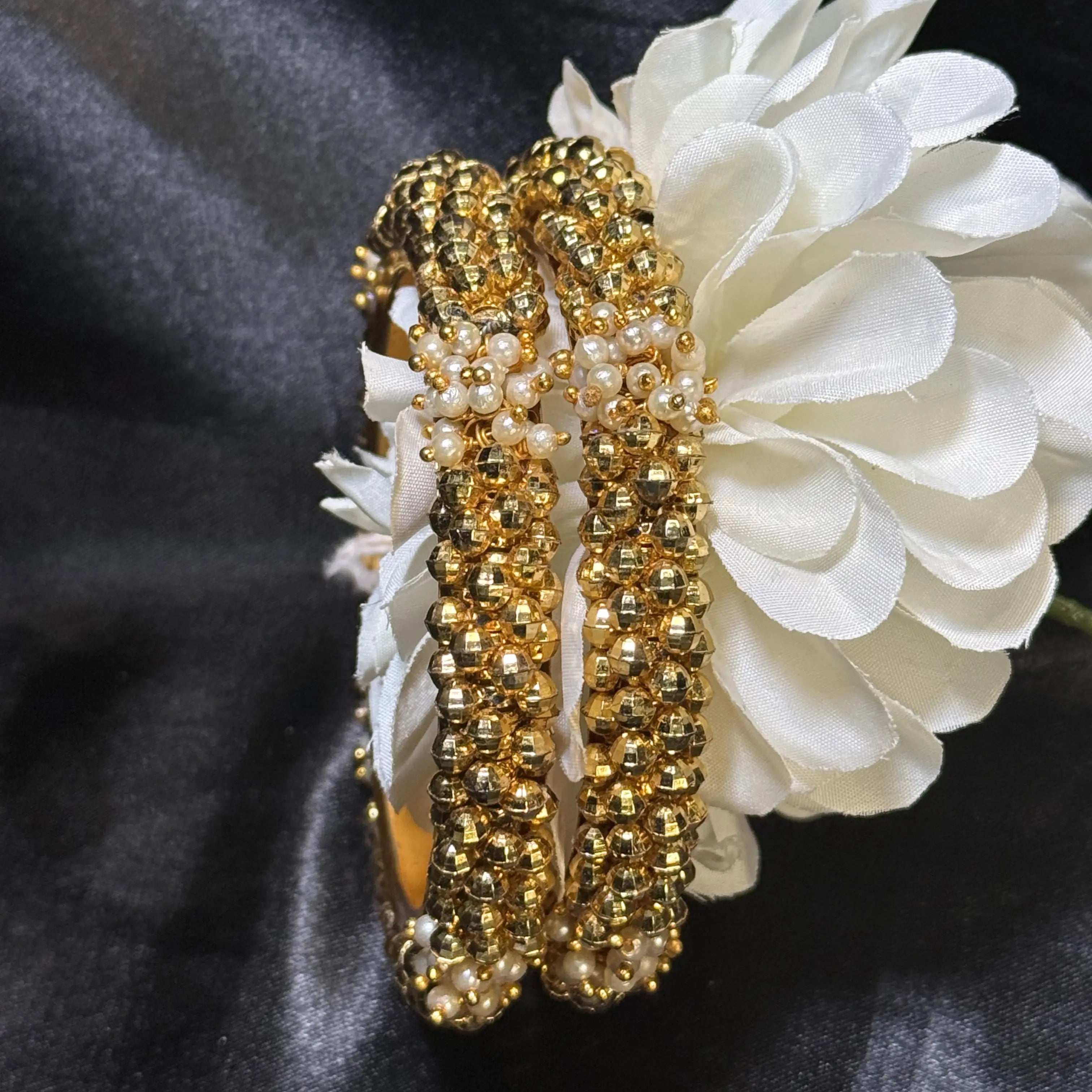 Ethnic gold bangle pair with intricate bead and pearl work