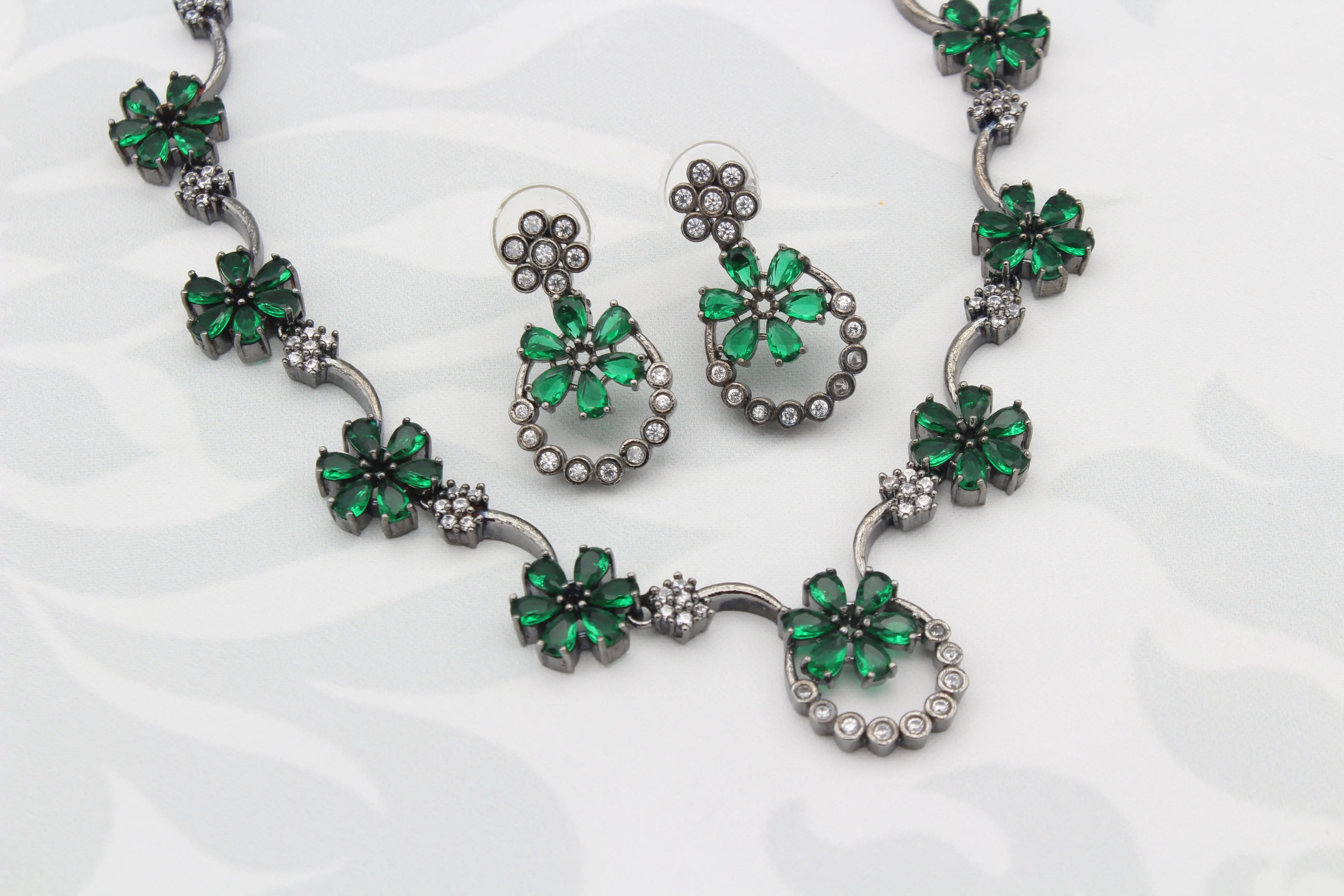 Close-up of Green Floral American Diamond Necklace Set with emerald-tone flowers and cubic zirconia stones