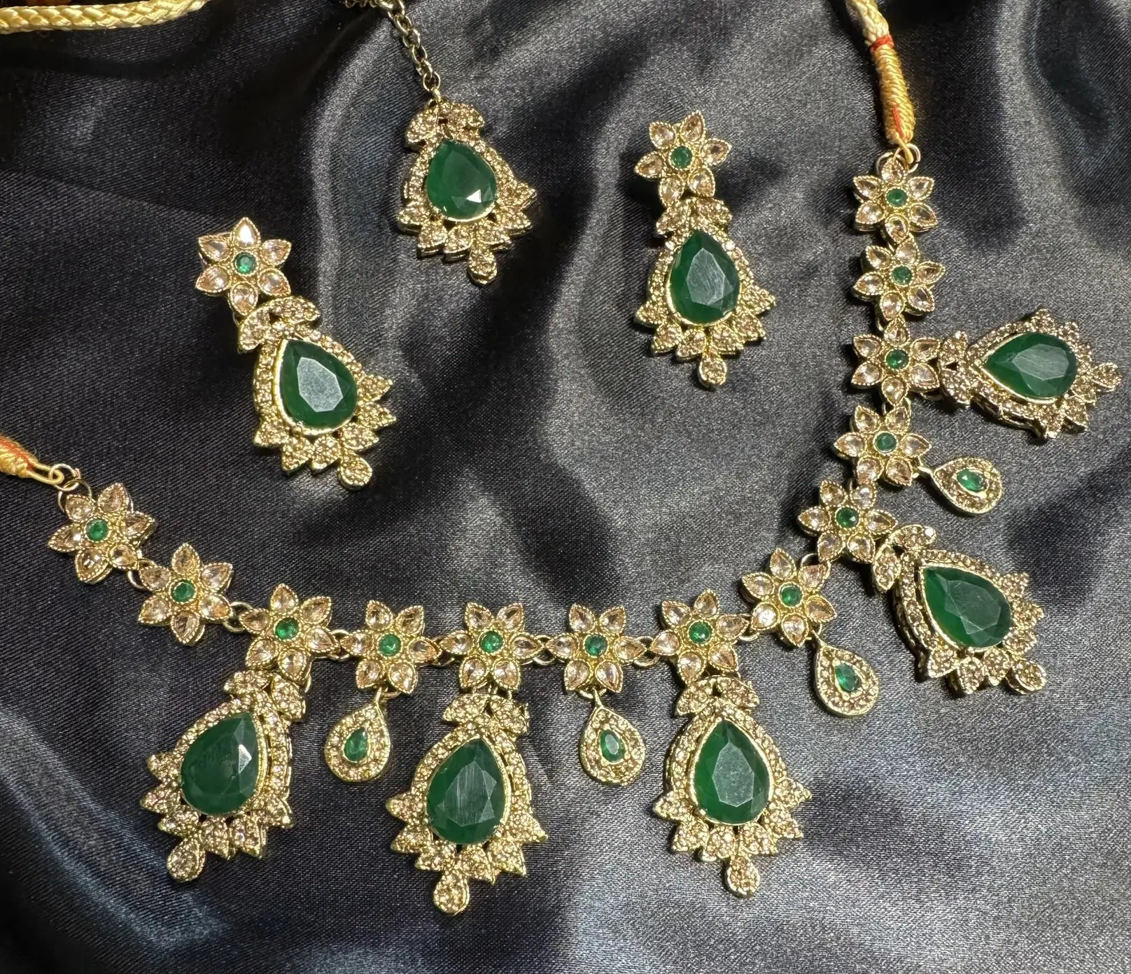 Emerald green bridal necklace set with teardrop center stones and CZ detailing, handcrafted in Pakistan, includes teeka and earrings