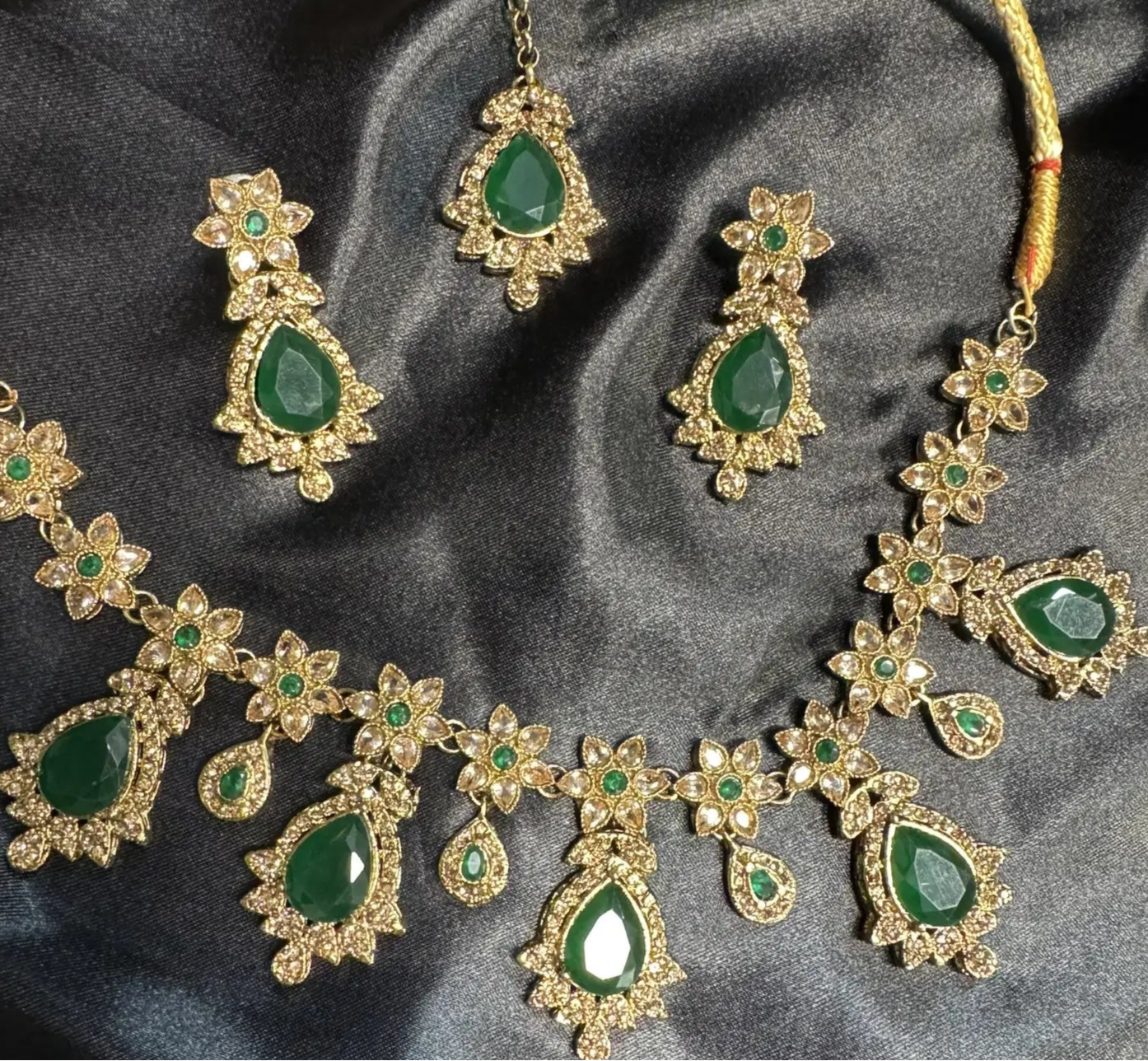 Full emerald necklace set with teardrop gemstones and intricate floral CZ pattern, gold finish, handmade jewelry for festive wear