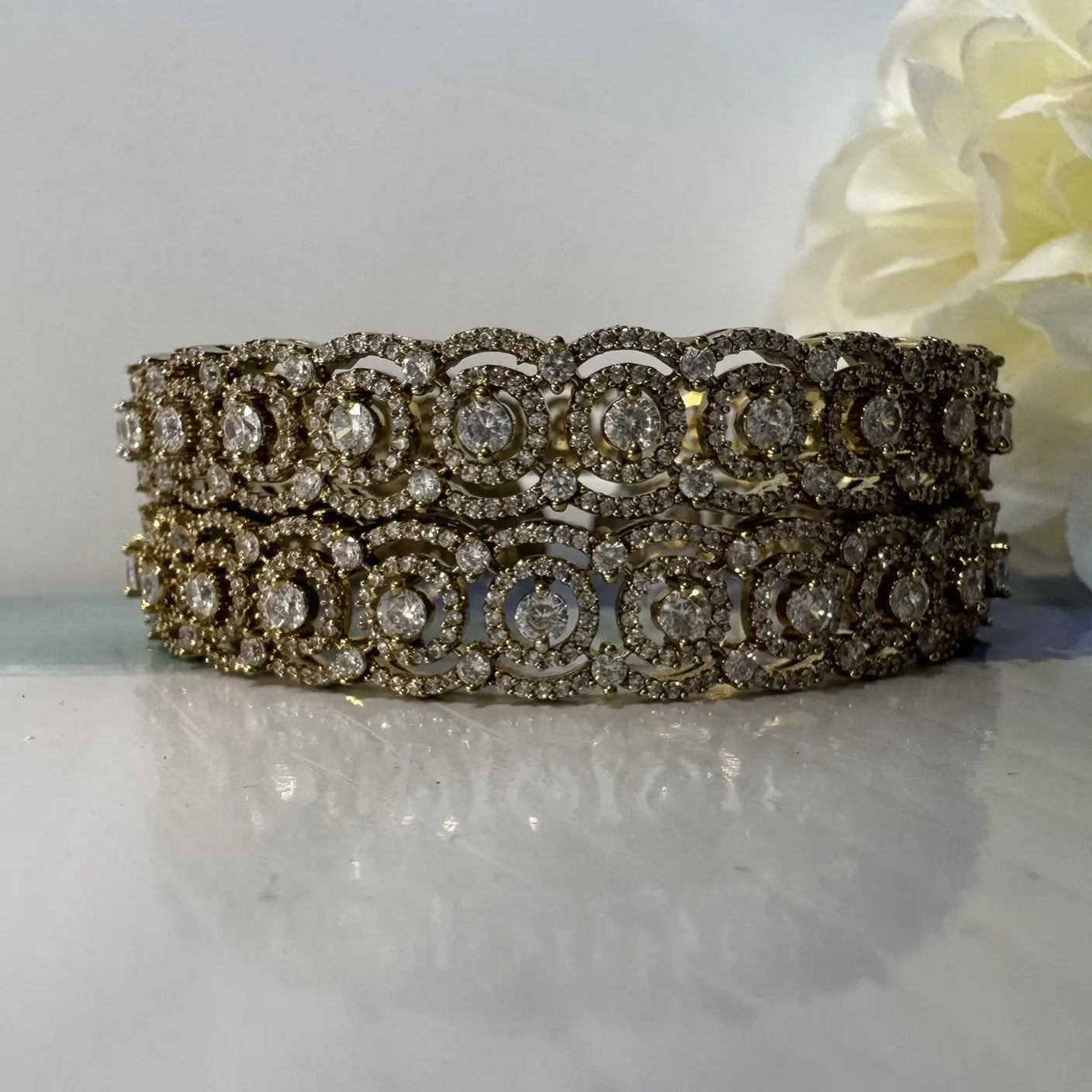 Gold-plated American diamonds bangles with antique polish for lasting shine and anti tarnish capabilities on a white background  