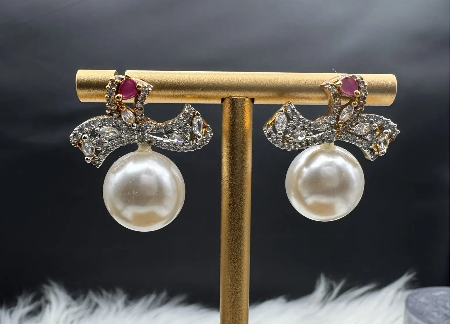 Pair of Pearl drop American diamonds earrings with hotpink colored stone