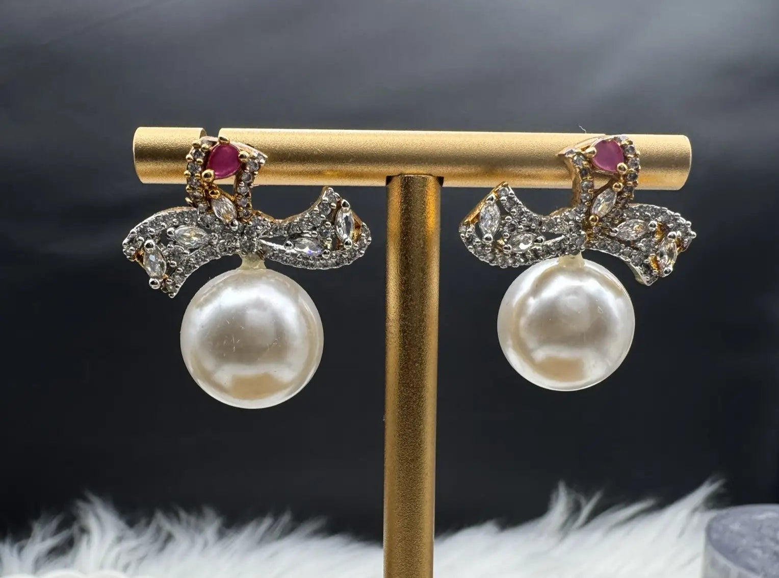 Pair of Pearl drop American diamonds earrings with hotpink colored stone