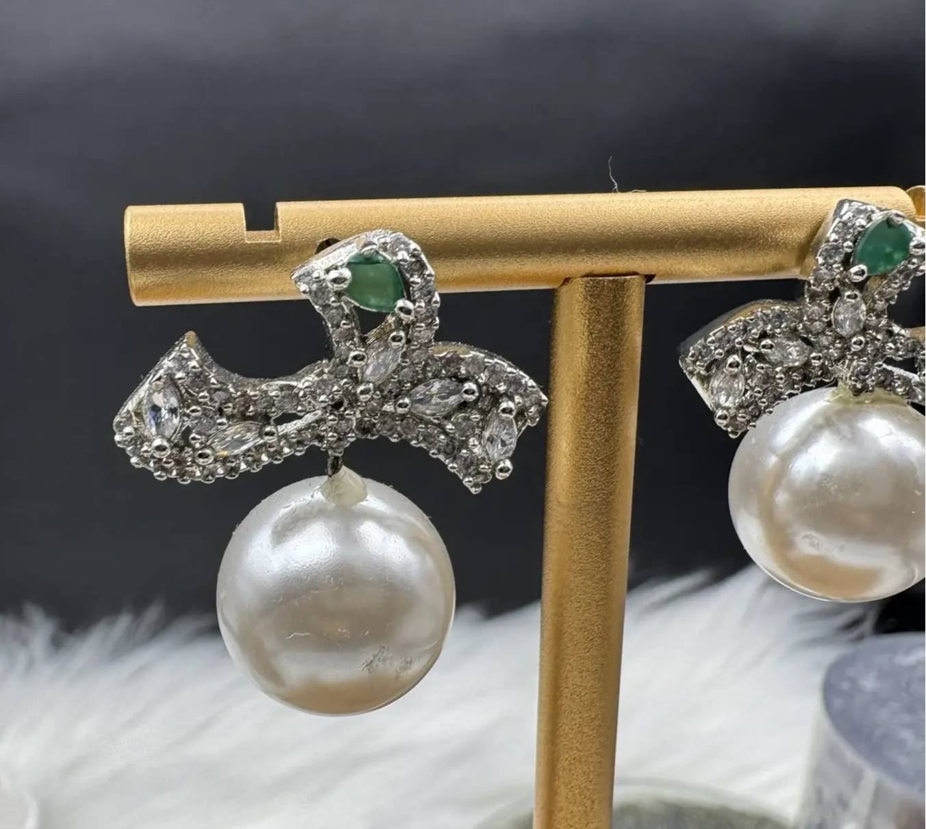 closer view of Pearl drop American diamonds earrings with teal colored stone