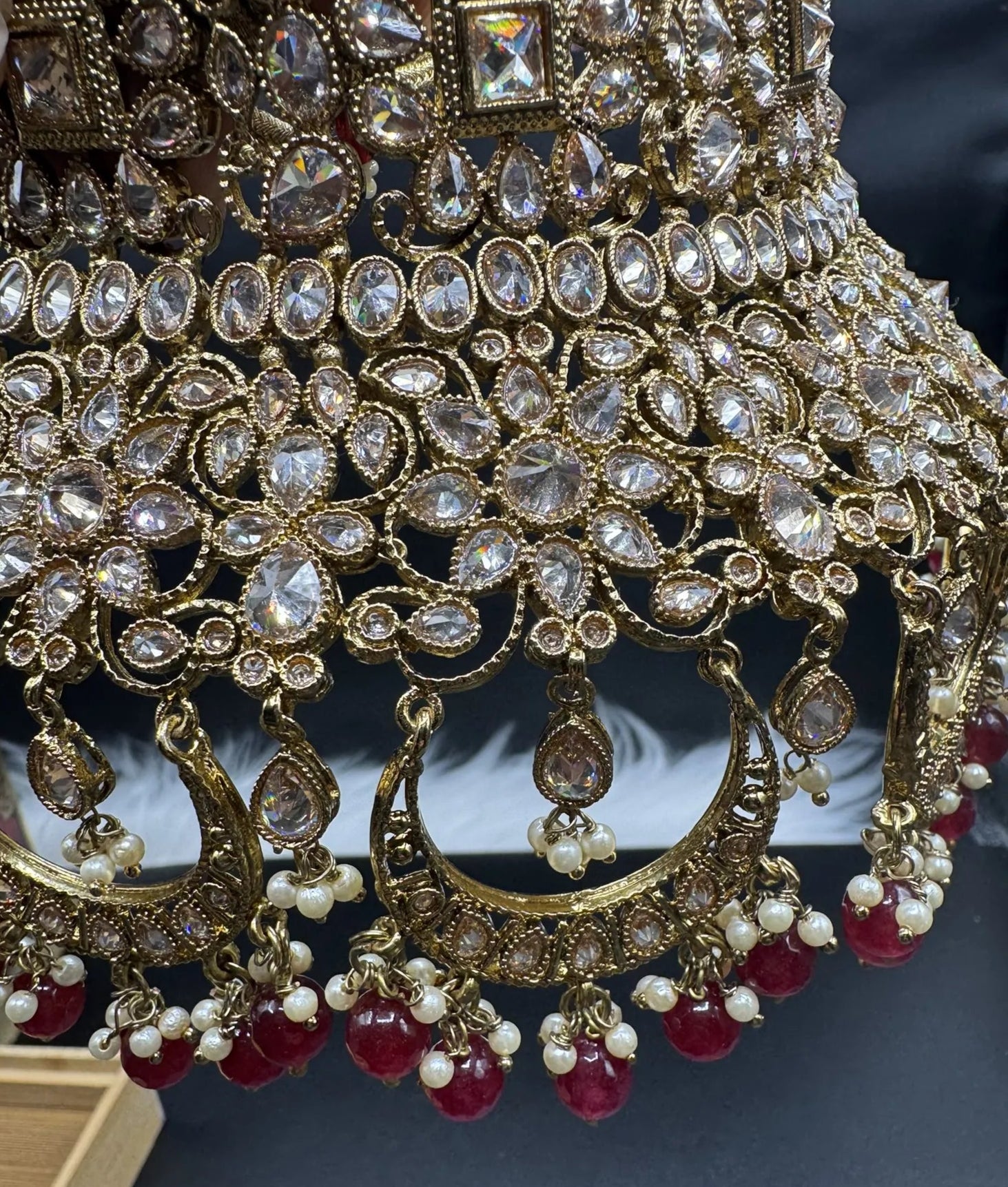 choker closeup view exquisite gold-plated Indian bridal set with red accents, sparkling stones & matching earrings, teeka and a long traditional necklace. Waterproof & anti-tarnish.