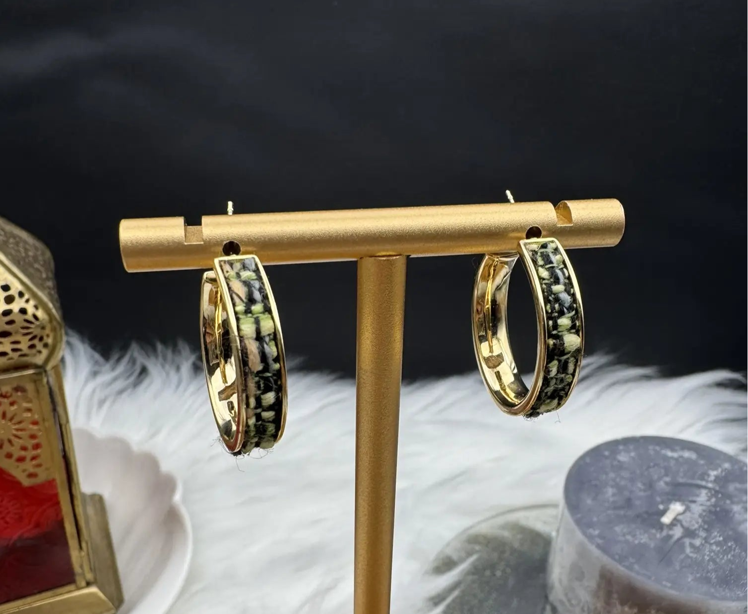 gold plated hoop earrings with camouflage style pattern on a stand