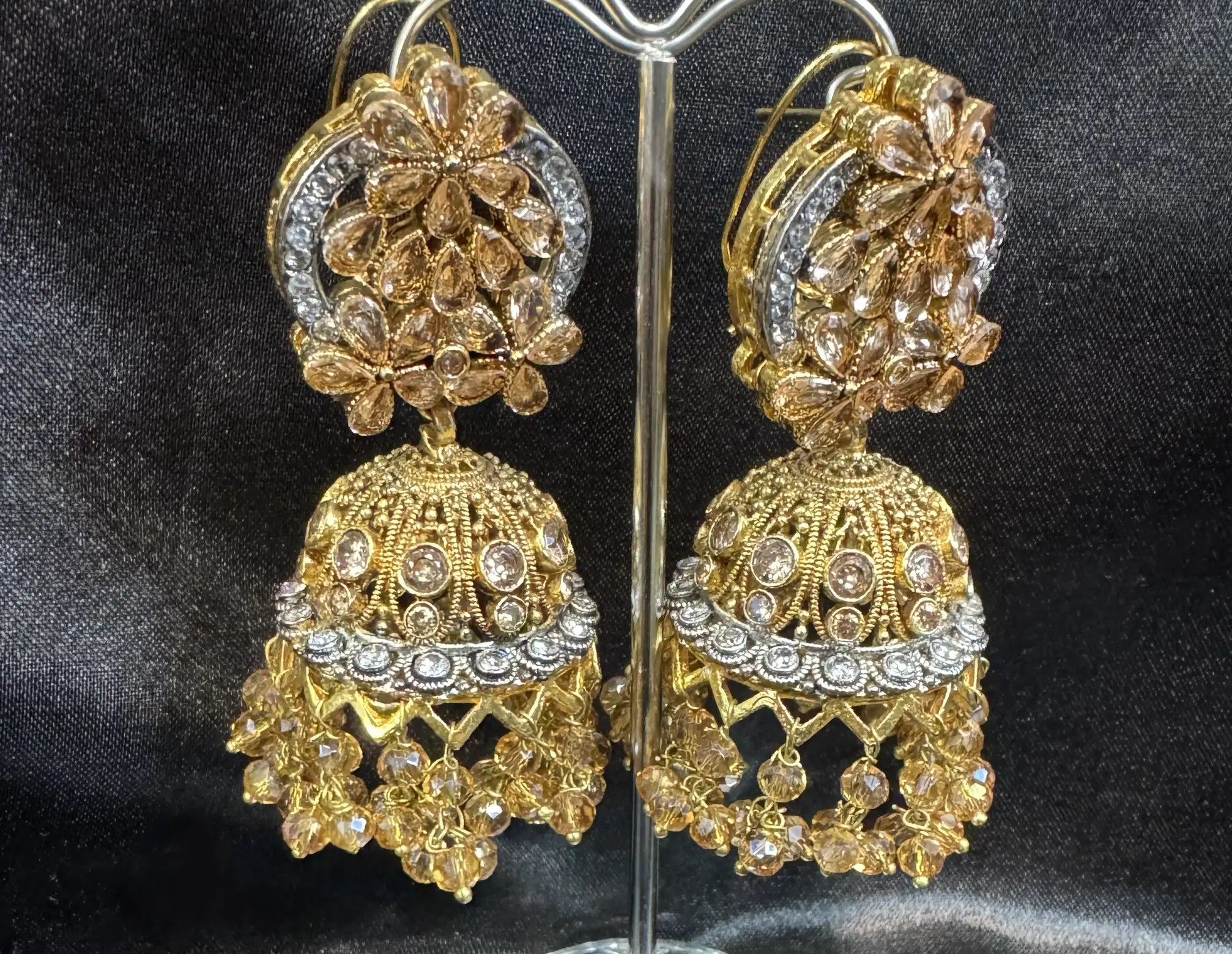 Pakistani design gold-plated jhumkay with champagne colored gemstones and floral accents